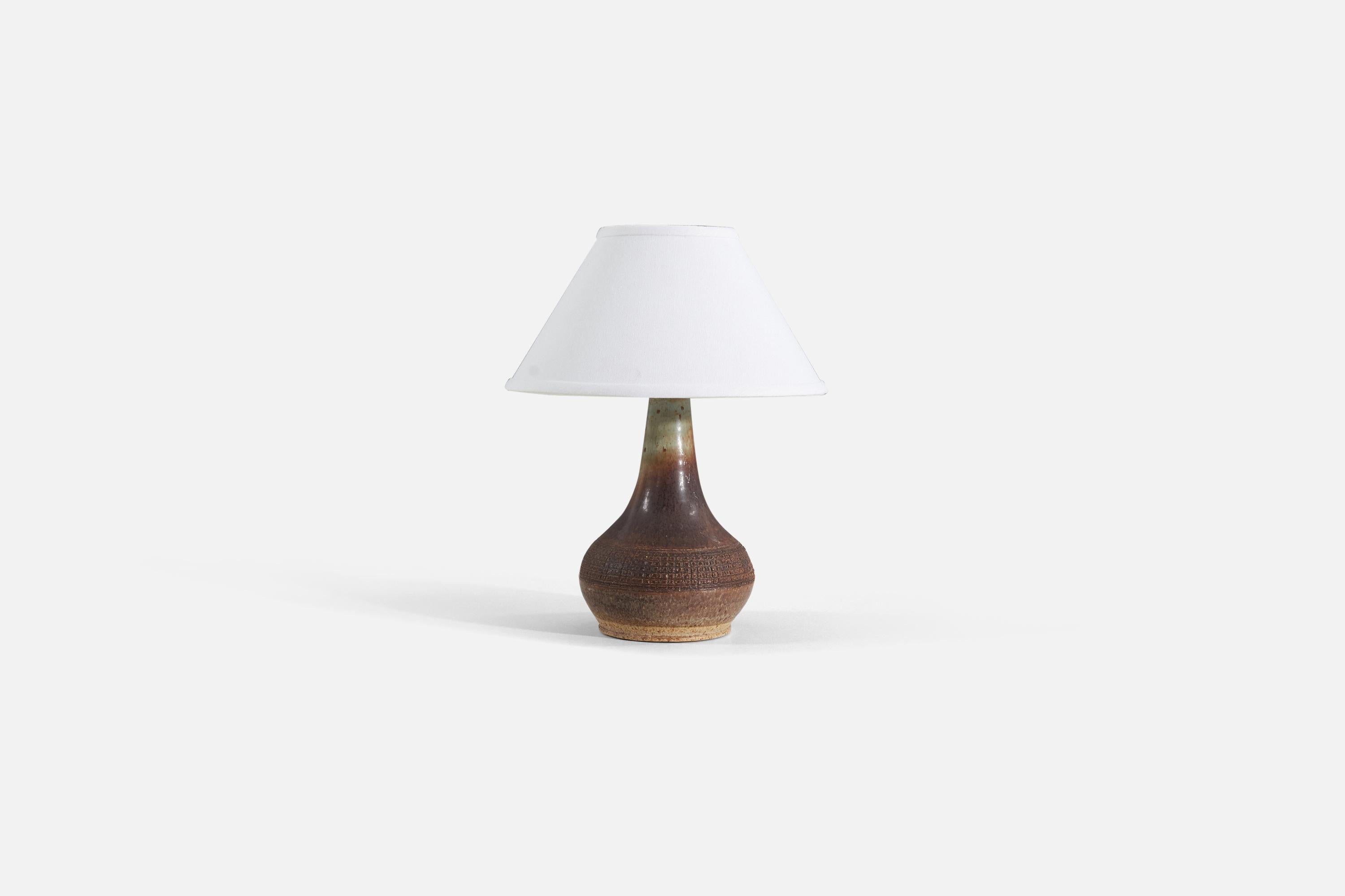 A brown and green glazed stoneware table lamp produced by Marco Stentøj, Denmark, 1960s.

Sold without lampshade. 

Measurements listed are of lamp. 
Shade : 4.5 x 10.25 x 6
Lamp with shade : 13.25 x 10.25 x 10.25.