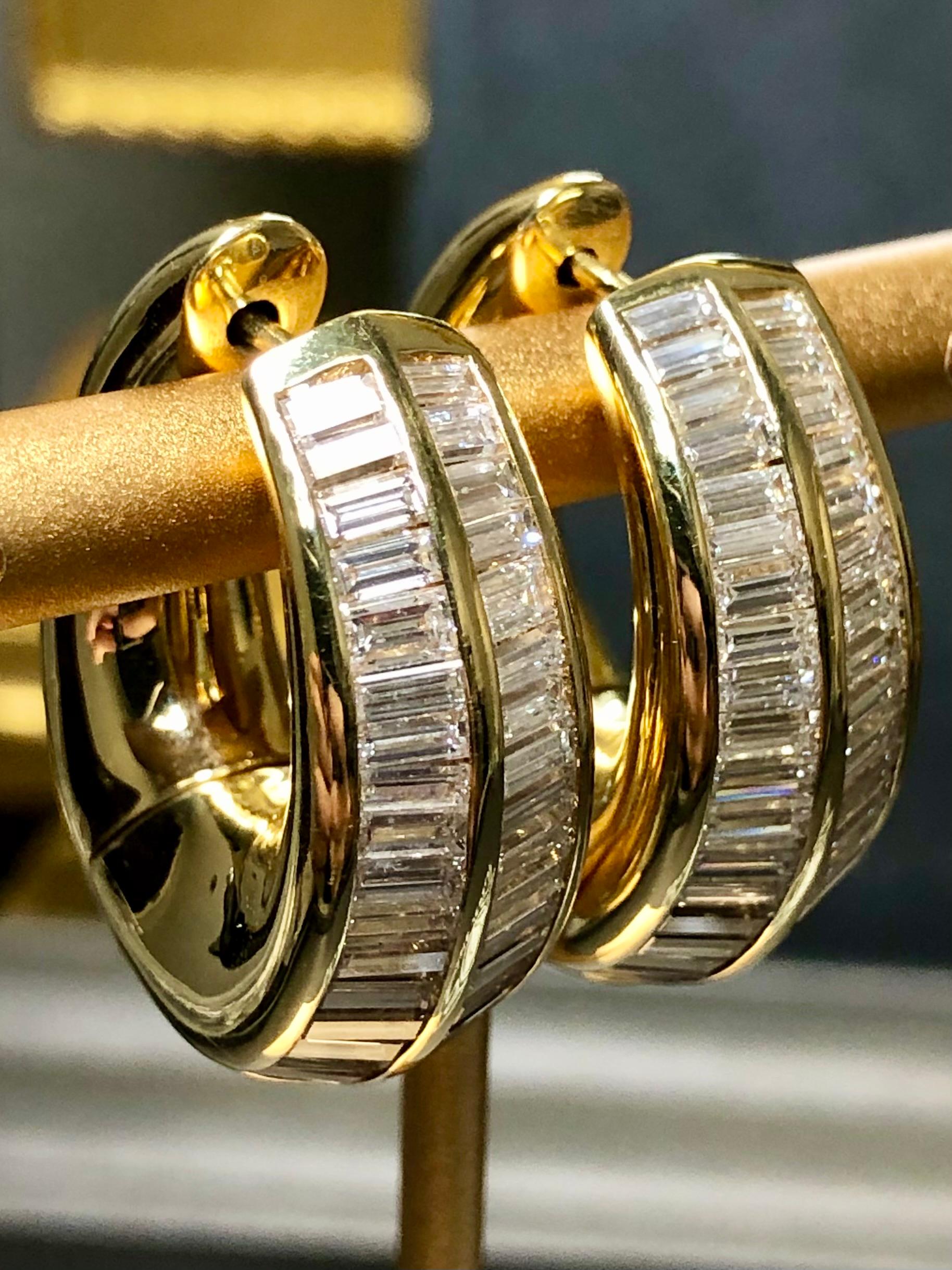 An impressive pair of hoop earrings by maker “MARCO VALENTE” done in 18K yellow gold and set with graduated baguette diamonds with an approximate total weight of 8cttw with all stones being G-H color and Vs1-2 clarity.

Dimensions/Weight
1” long and