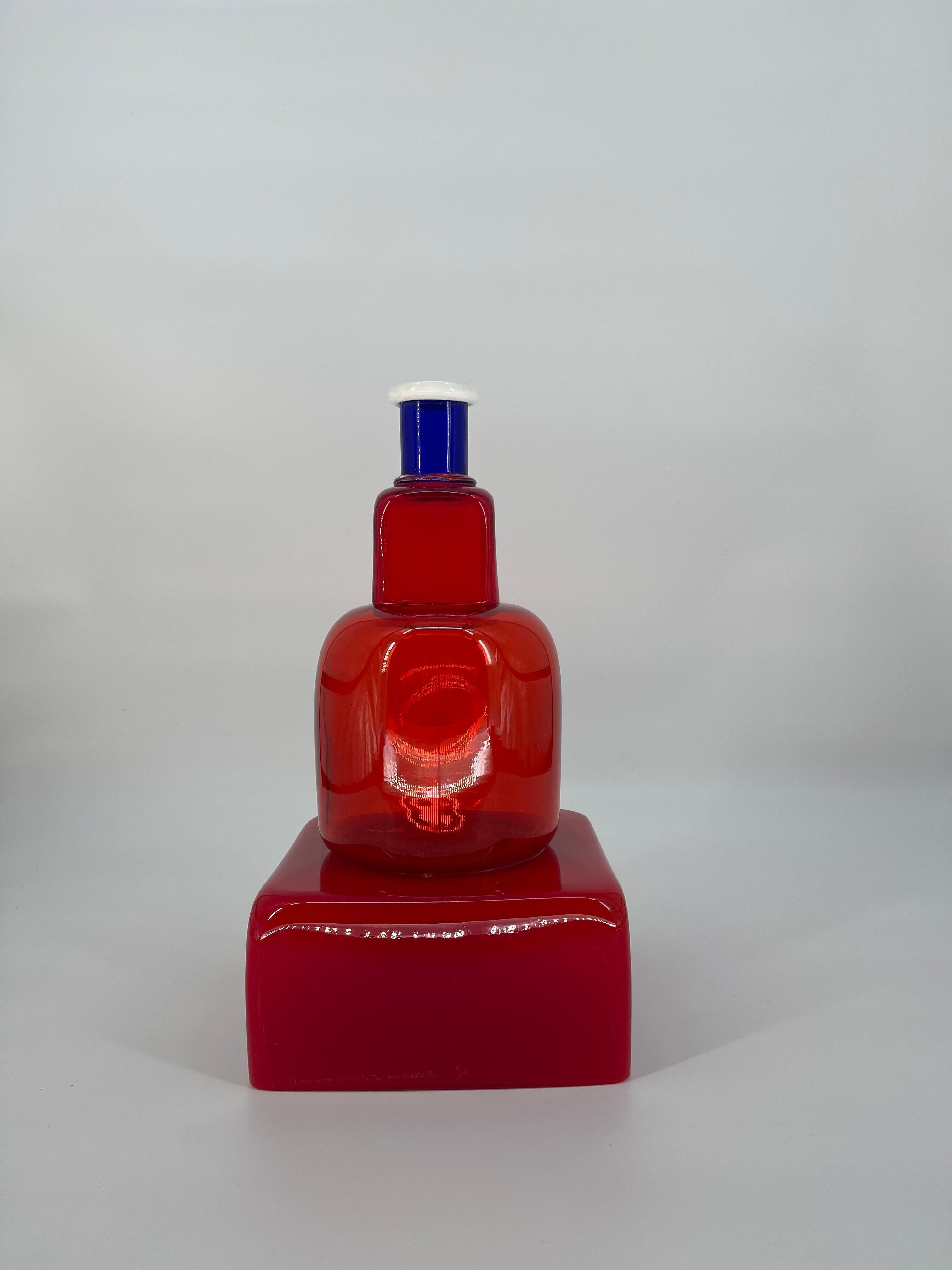Marco Zanini for Memphis, designed in 1986
KITA, A RED CLEAR GLASS VASE
Pyramid shaped red vase with white and blue detailing
Engraved mark M. Zanini per Memphis by Toso Vetri d'arte Provo d'autore
This vase is number 1 of 7.