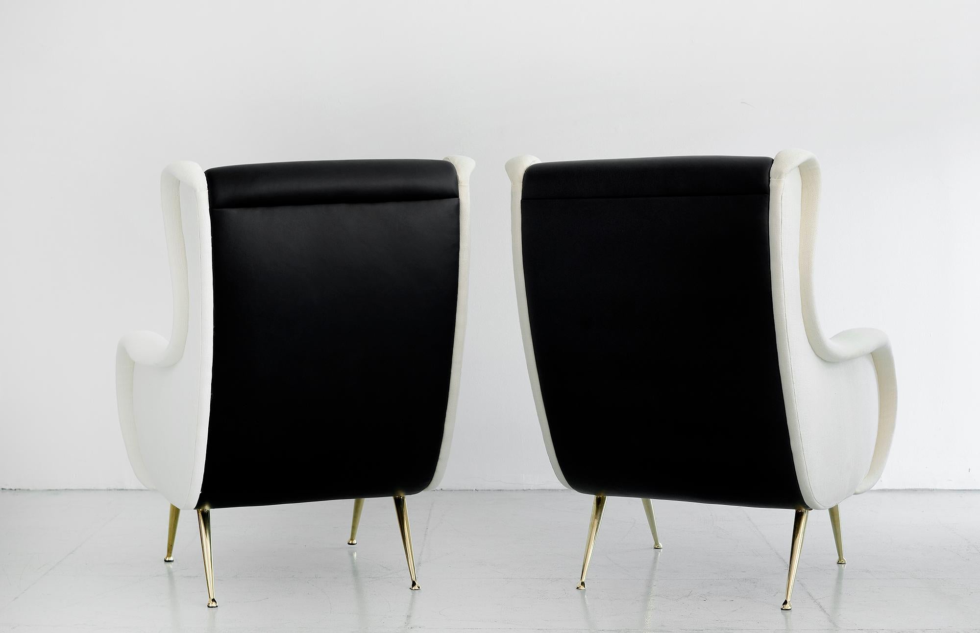 Handsome Marco Zanuso attributed club chair with signature curved lines, brass legs and reupholstered in black seat and backs with contrasting white linen arms.
