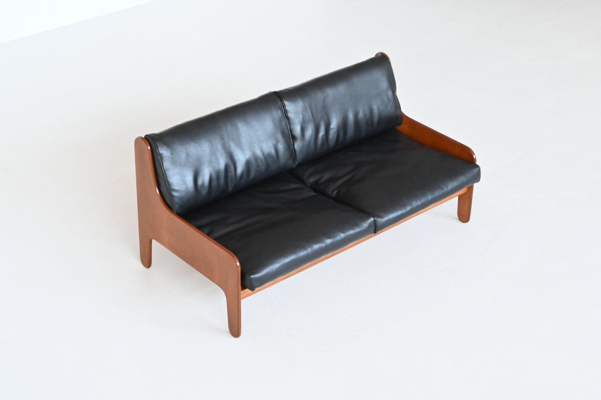 Stunning shaped lounge sofa model Baronet designed Marco Zanuso and manufactured by Arflex, Italy 1964. This amazing sofa has a very nice teak plywood frame and the cushions are covered with high-quality black faux leather. The plywood frame is a