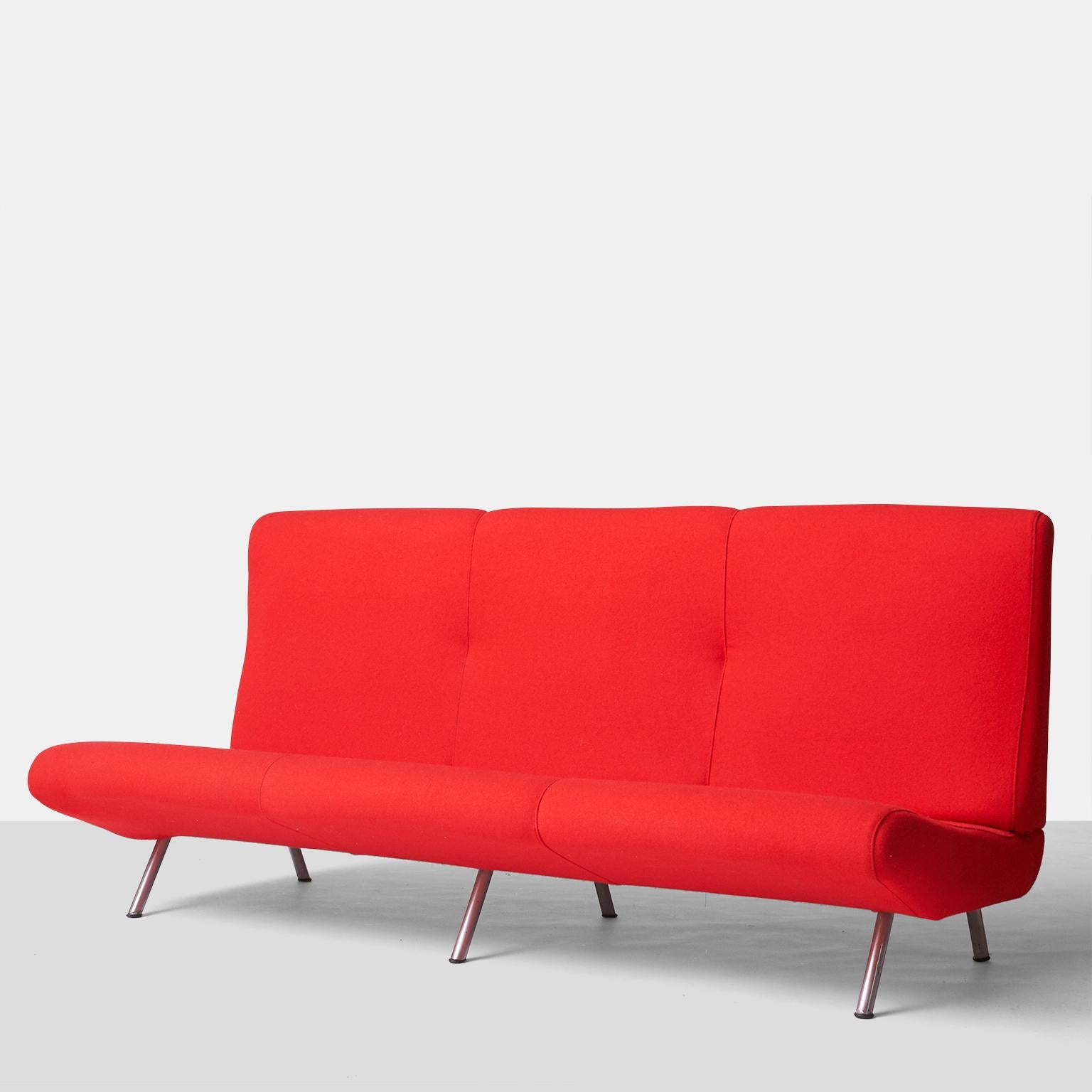 A three-seat sofa by Marco Zanuso for Arflex, in cherry red wool. Features an armless, low seat, high back, and matte-chromed steel legs. Marked accordingly on a fabric label.
Produced in Italy.

Would benefit from restoration. 