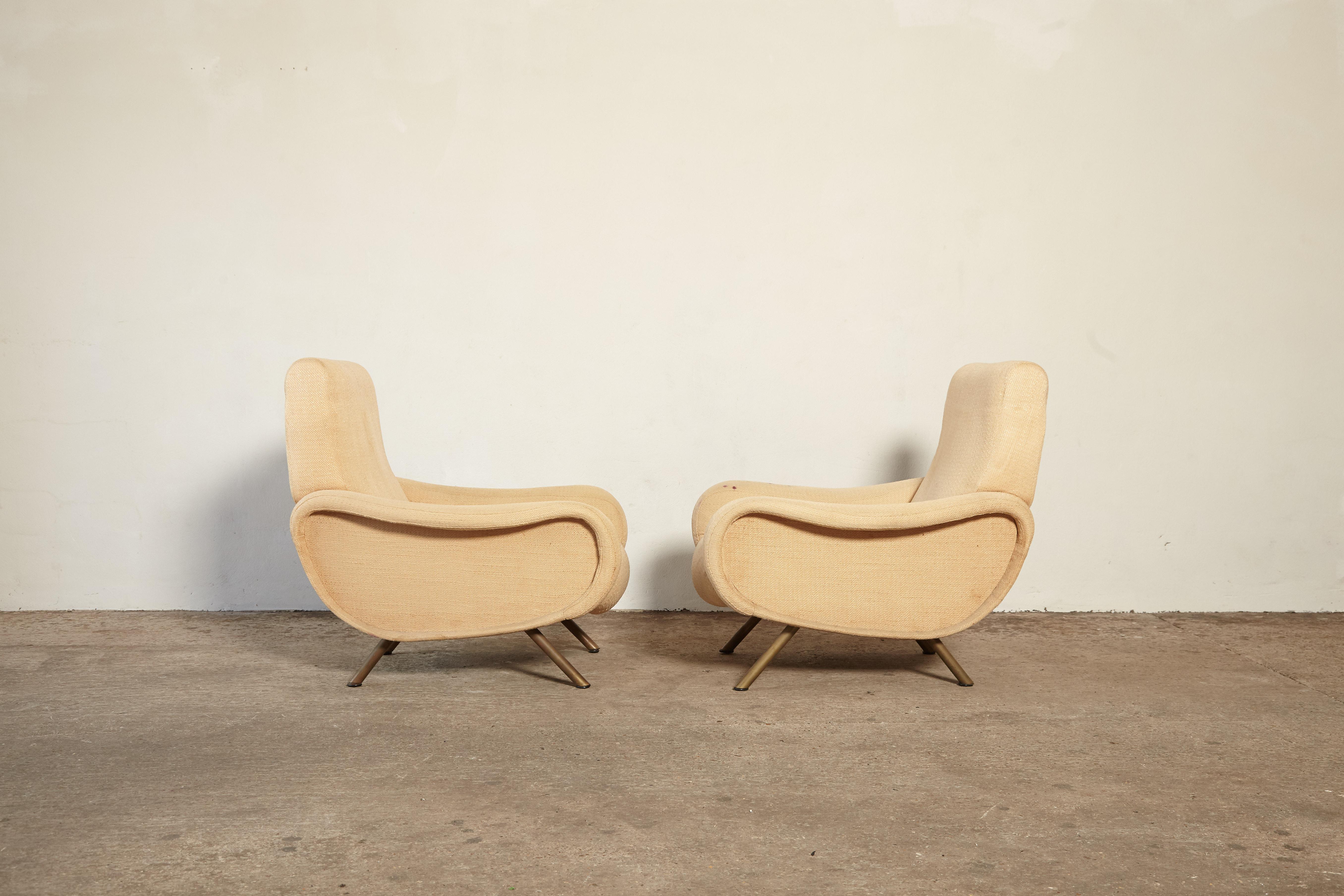 A pair of original and authentic Marco Zanuso Lady chairs, Arflex, France/Italy, 1950s. The upholstery is worn and stained so the chairs require re-upholstery so the price here includes re-upholstery in customer supplied material. Fast shipping