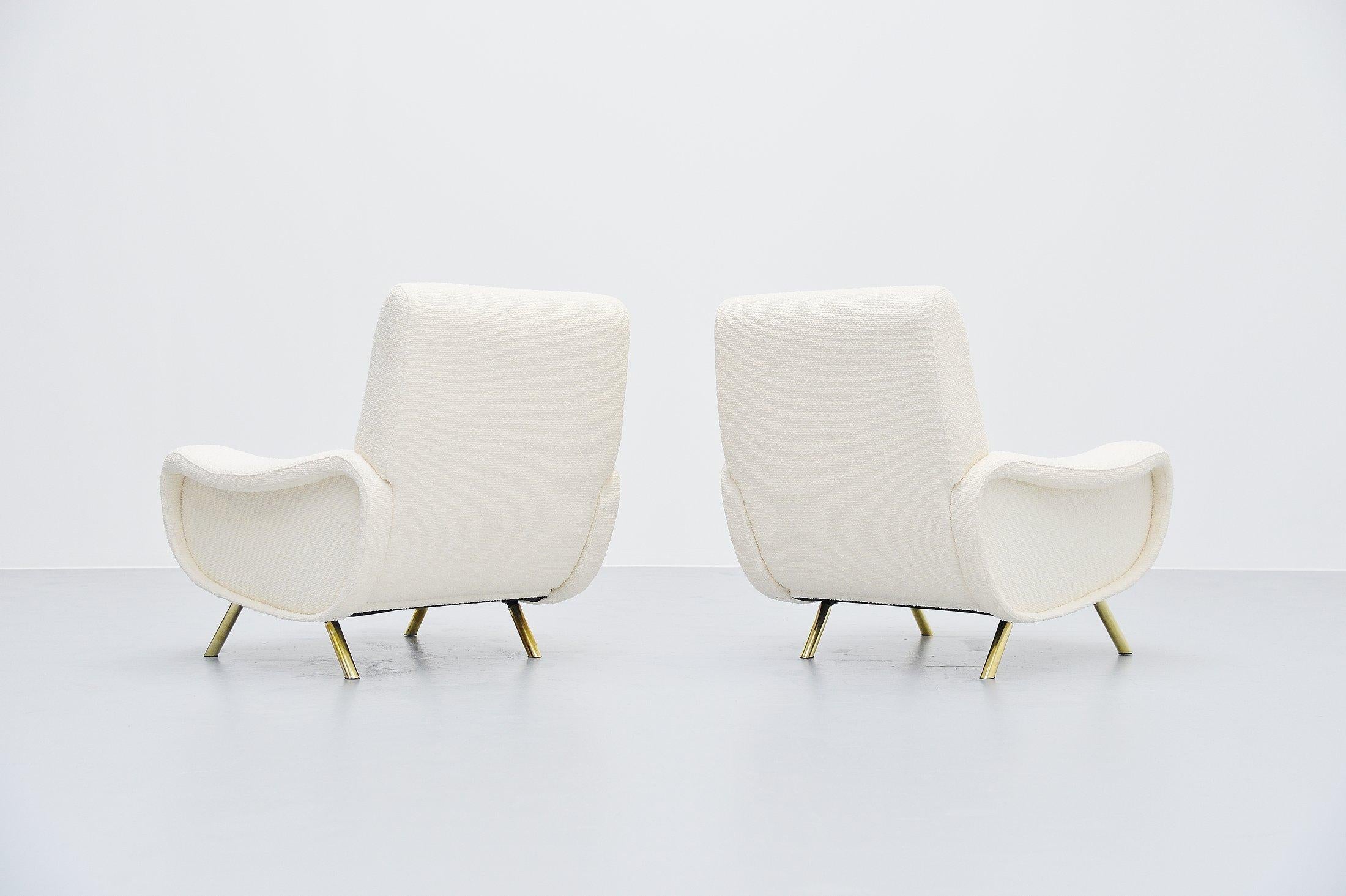 Iconic so called pair of 'Lady chairs' designed by Marco Zanuso and manufactured by Arflex, Italy, 1951. These lady chairs have brass covered legs and they are newly upholstered in boucle fabric from Pierre Frey. The upholstery looks amazing on