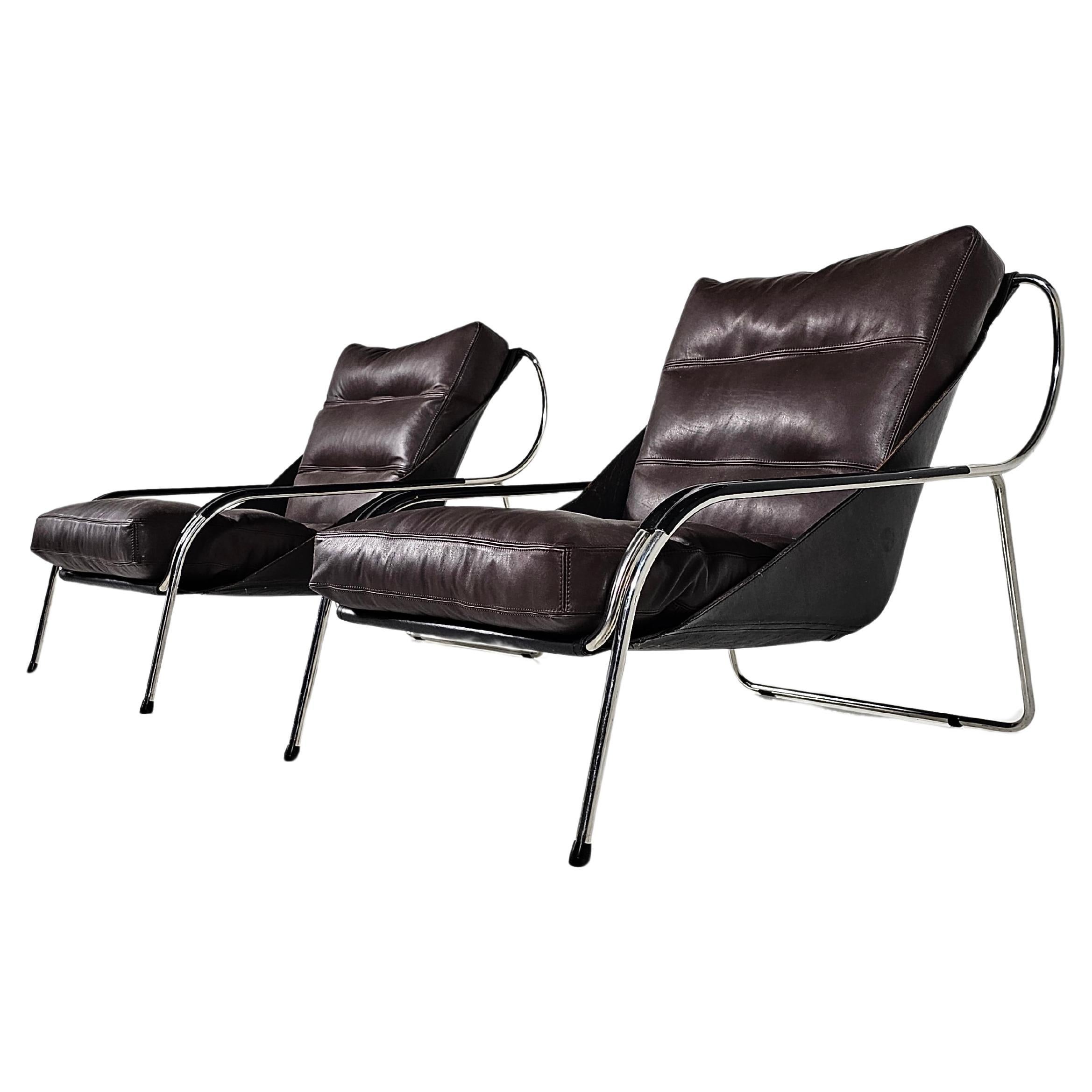 1st edition Maggiolina chairs by Zanotta designed by Marco Zanuso, the 1950s. The black cowhide sling supports one large newly upholstered brown leather cushion with a goose feather filling.  A stainless steel frame supports this very comfortable