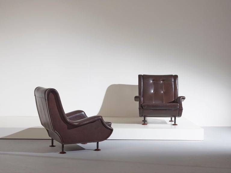 A pair of Regent armchairs with black lacquered metal legs and walnut disk feet. Designed by Marco Zanuso for Arflex. 

Dimensions: 79 x 83 x 81 cm [DxWxH]

Condition: Some stains and abrasions on their leather. Overall good vintage