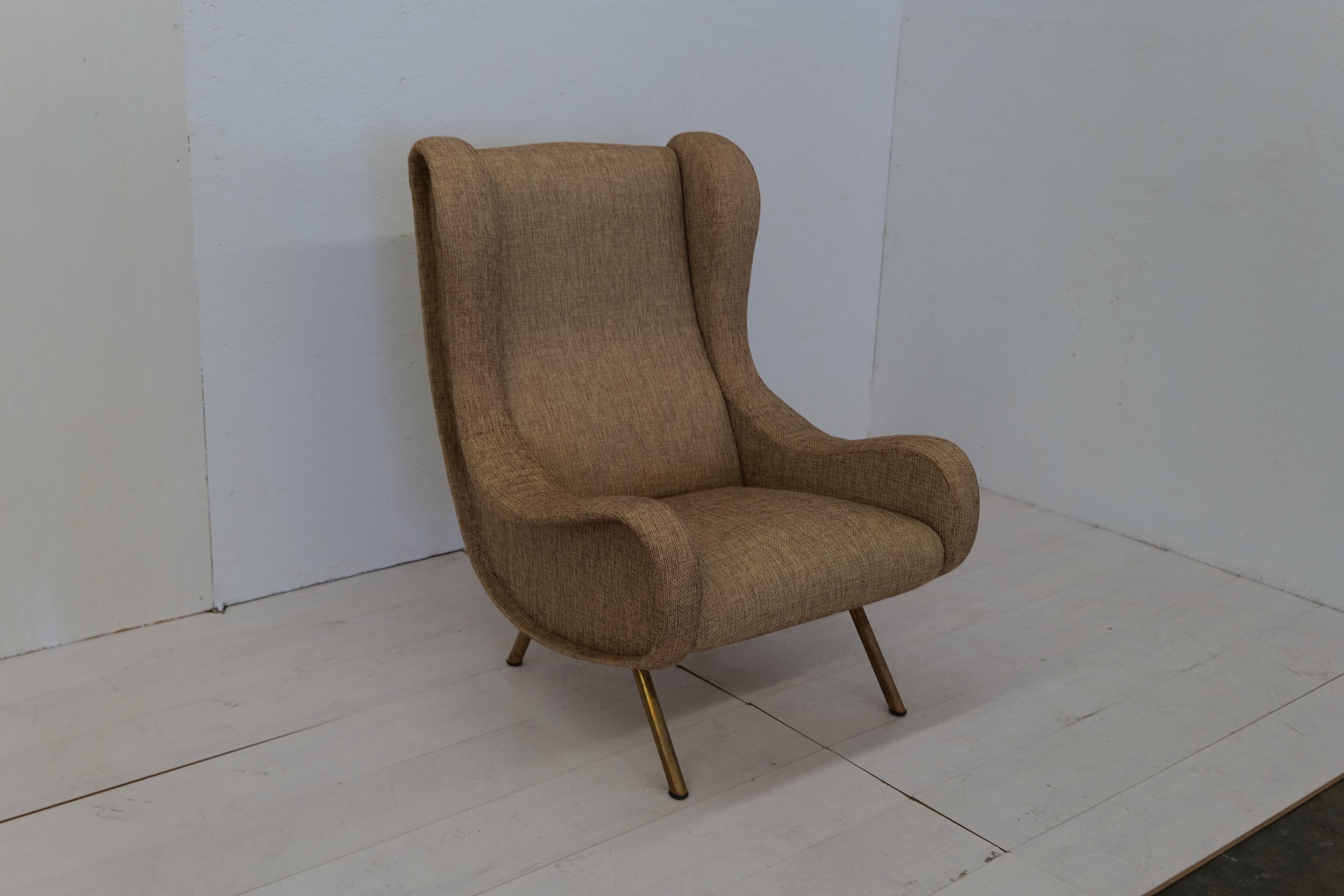 The Marco Zanuso Senior Armchair for Arflex, designed in the 1950s, is an iconic piece featuring brass legs that add a touch of luxury to its sleek and elegant design.

