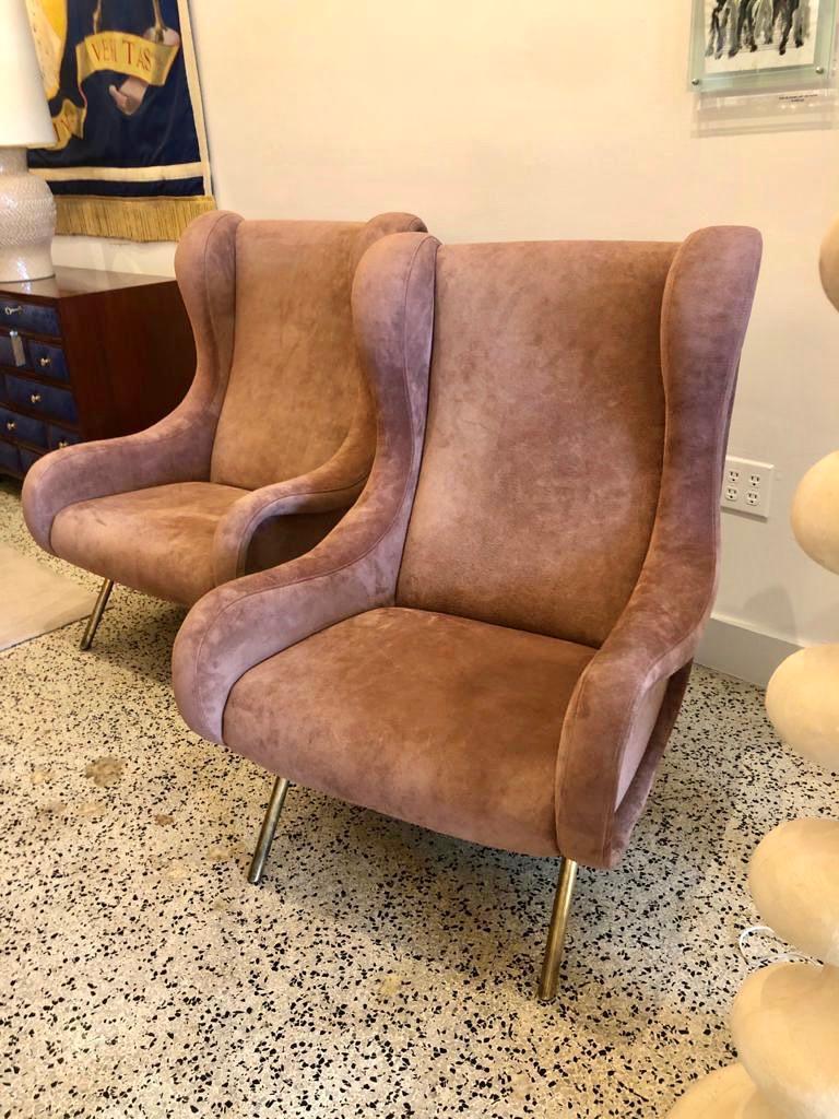 These wonderful and iconic ZANUSO Senior armchairs retain the original Arflex label to underside. Upholstered in a soft dusty rose suede leather which accentuates the tones of this leather beautifully. Wide and deep so very comfortable for any sized