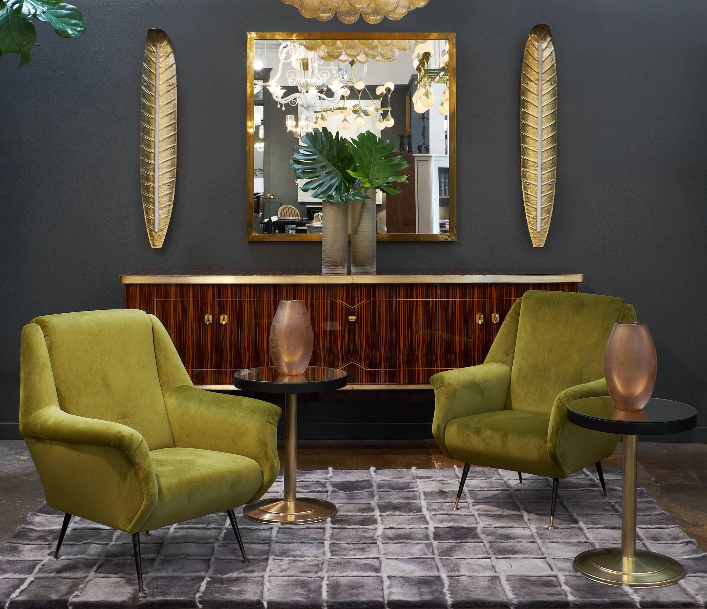 Pair of Marco Zanuso style armchairs from the midcentury upholstered in the original green velvet. This Italian pair has the geometric shape and arms typical of the Zanuso style. The four tapered legs are each capped with brass. These fantastic