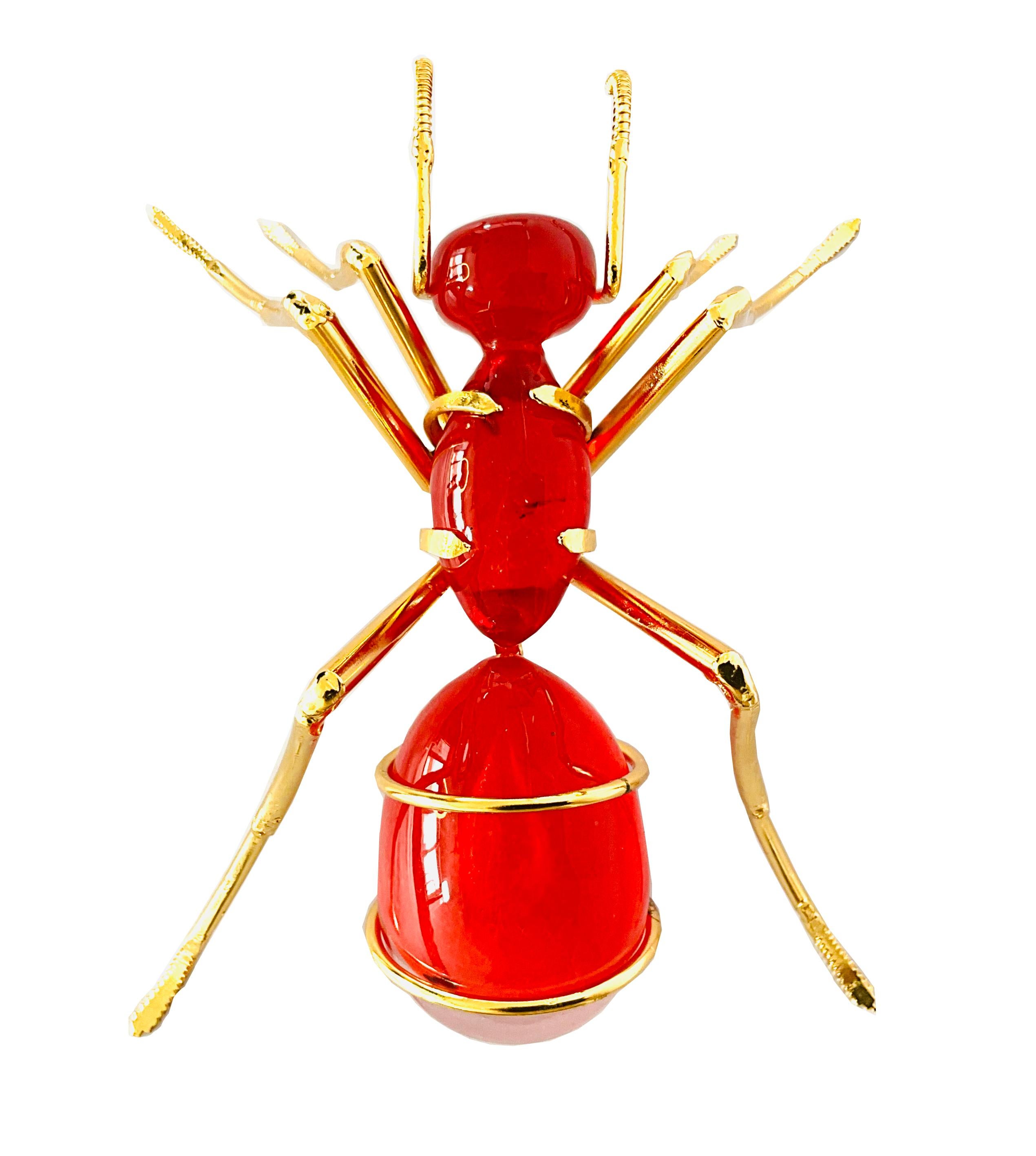 The Ant, Gold Plated and Red Glass

The sculpture by Marcos Romero, representing an ant made of recycled industrial iron and blown glass, is a fascinating work of contemporary art. Romero has created a piece that combines the hardness and resistance
