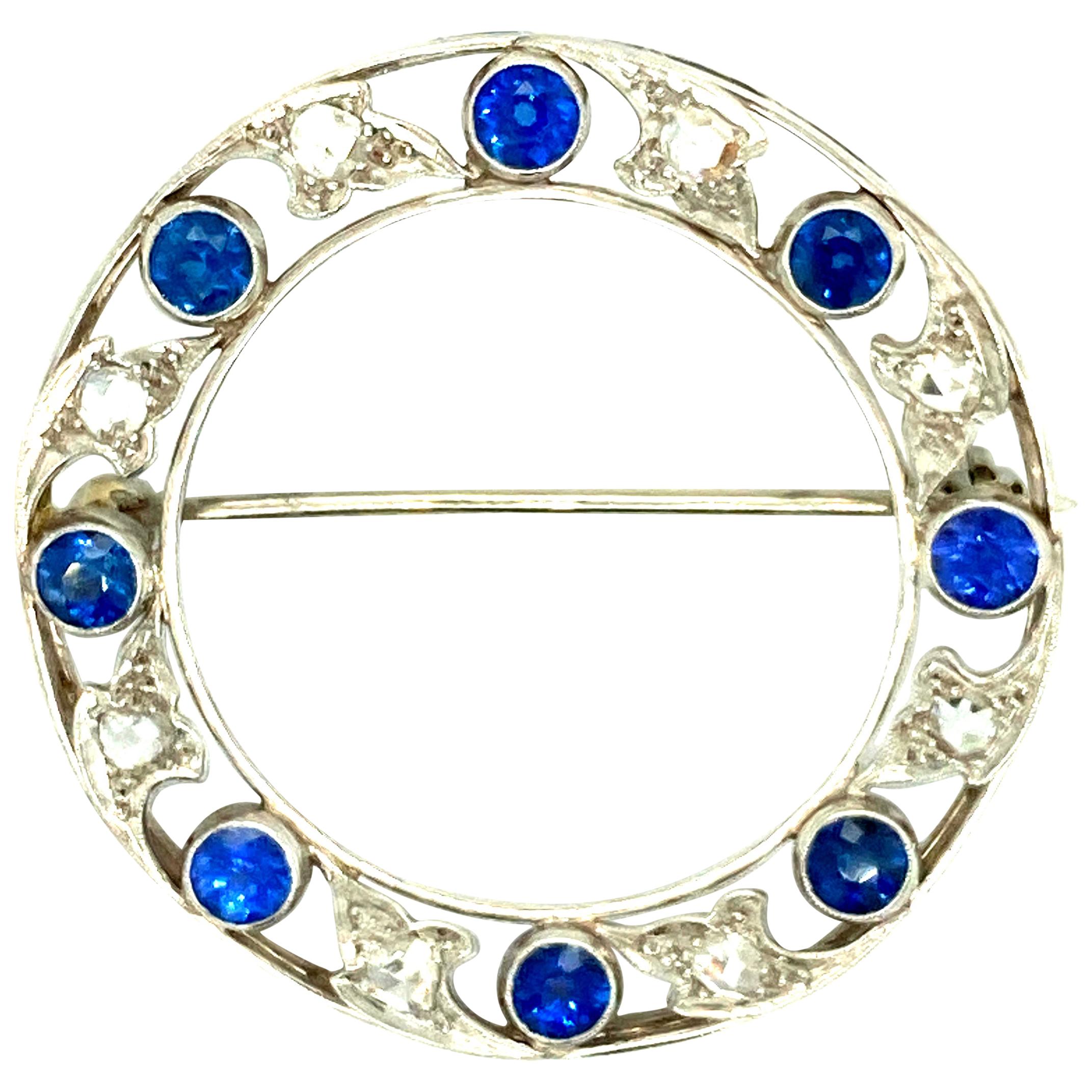 "Marcus" Art Deco Yogo-Montana Sapphire and Diamond Circle Brooch For Sale