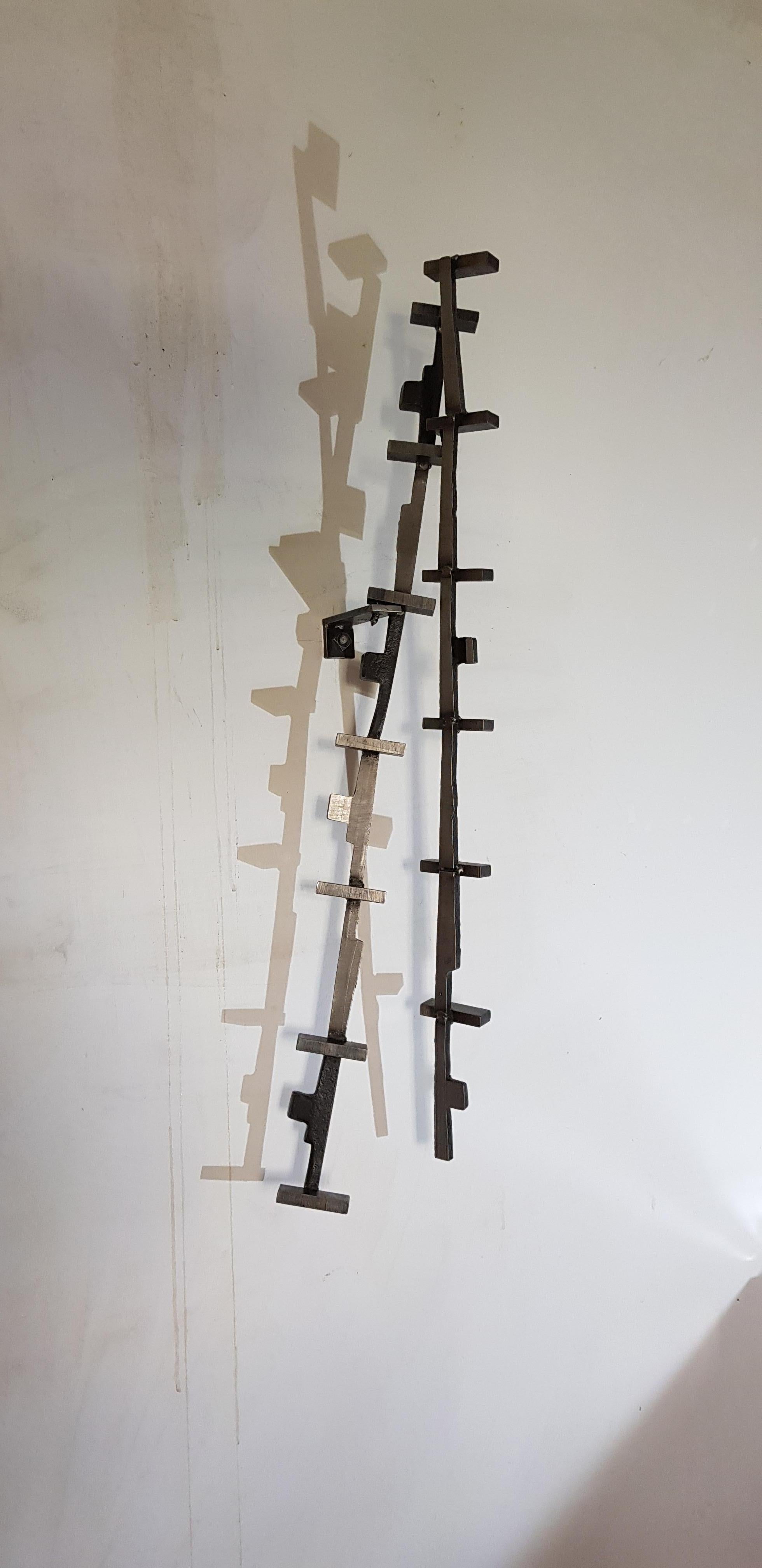 Marcus Centmayer - "Kinetic Series - The Pendulum 01/23".

"The Pendulum" kinetic sculpture made of steel, cut, welded, brushed.
Using small iron (= railway fittings) that the artist found and collected while working on his premises:
"With the