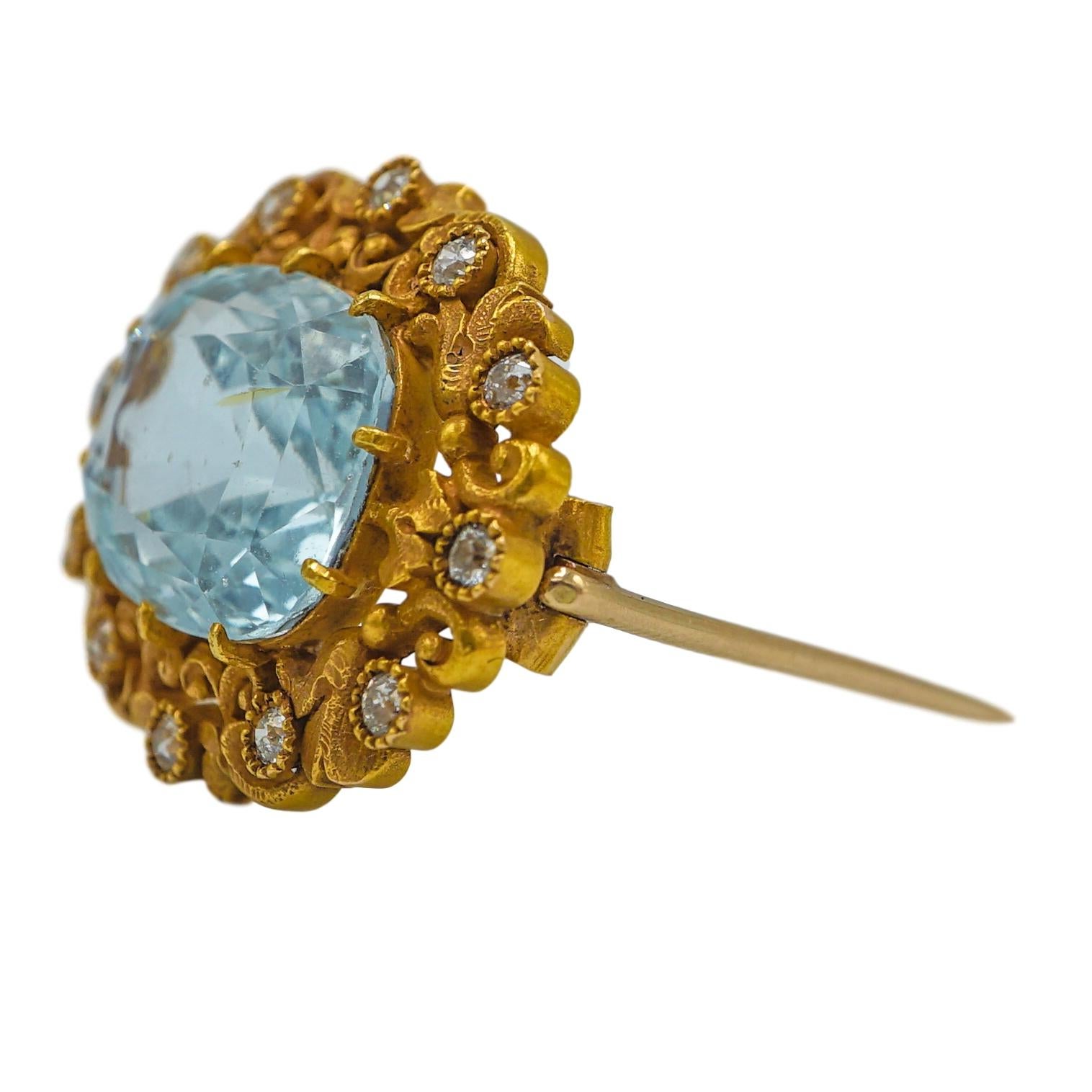 A Marcus & Co cushion-faceted aquamarine, approx. 11.87 cts. by formula, centered by scrolling gold acanthus leaves and OMC diamonds, approx. .30 ct. TW. Ca.1910. 18k. Stamped by the maker, M&Co. 3/4