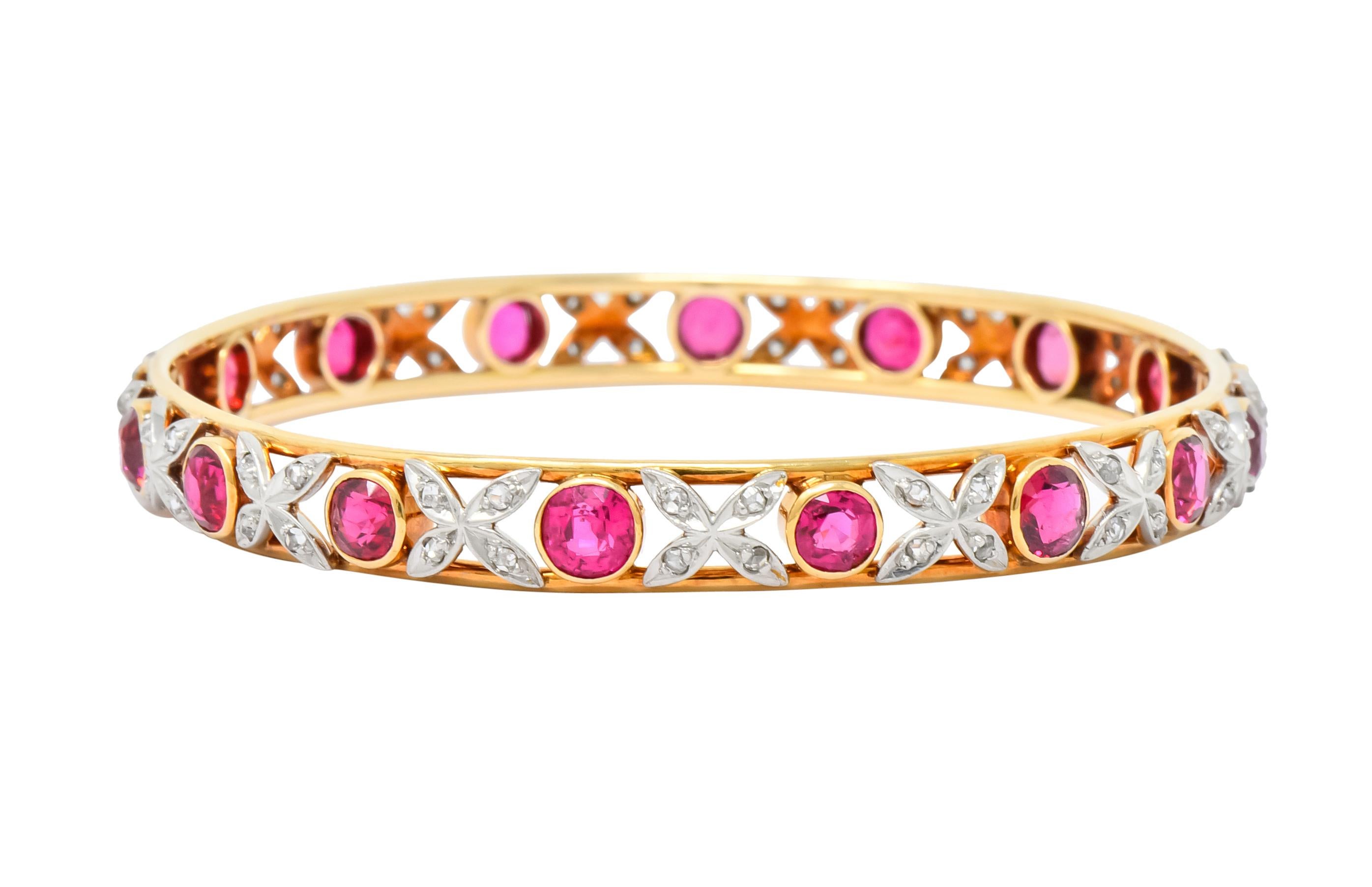 Pierced bangle bracelet with polished gold edges decorated throughout with platinum floral motif

Bezel set fully around with round cut spinel weighing approximately 9.00 carats total; raspberry to strawberry red in color - quality is consistent