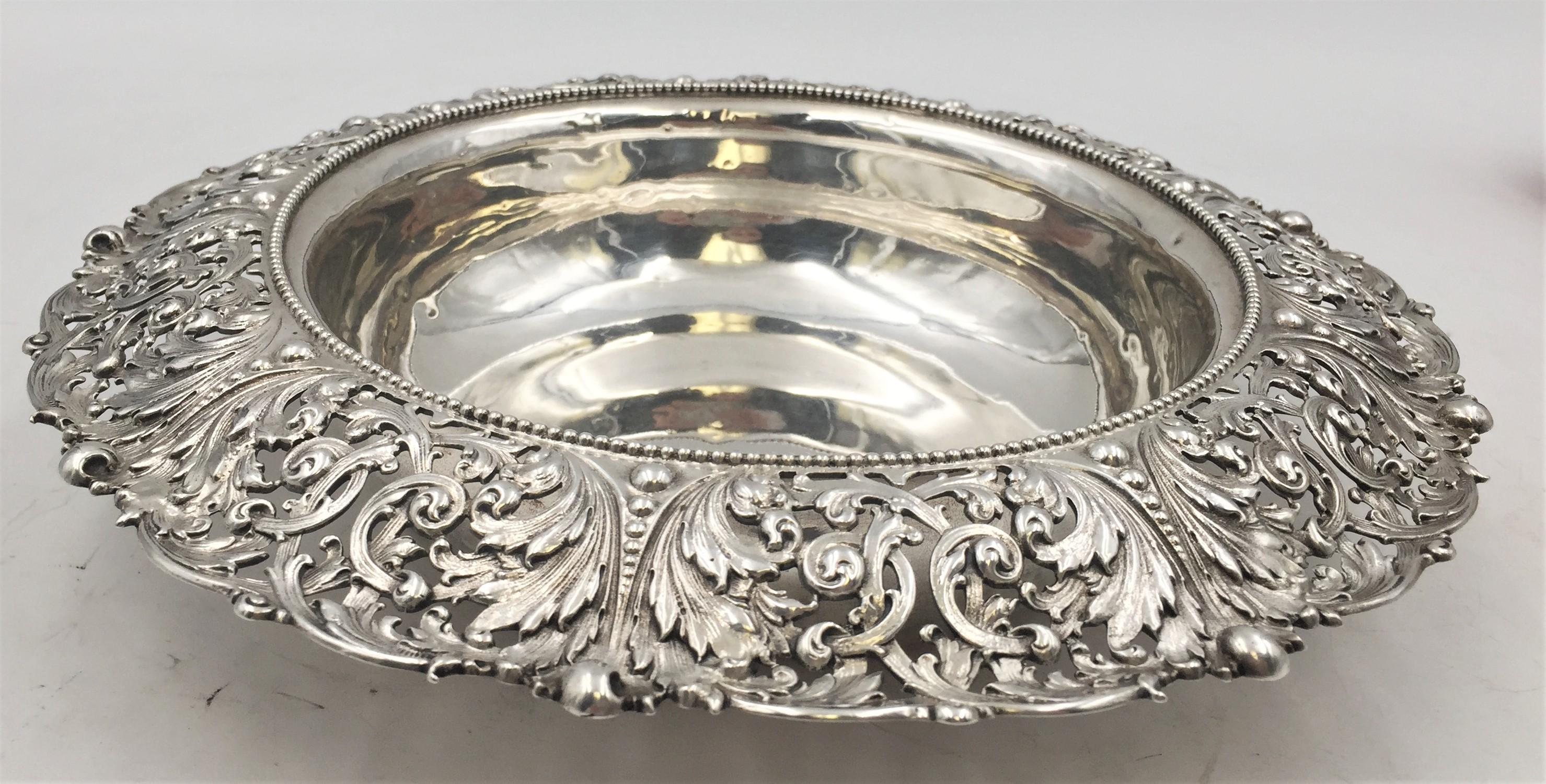 Sterling silver centerpiece or bowl by Marcus & Co with detailed foliate and scrolls. Measuring 10 inches in diameter and 2 1/2 inches in height and weighing 15.65 troy ounces. Bearing hallmarks as shown in images.

Herman Marcus came to New York