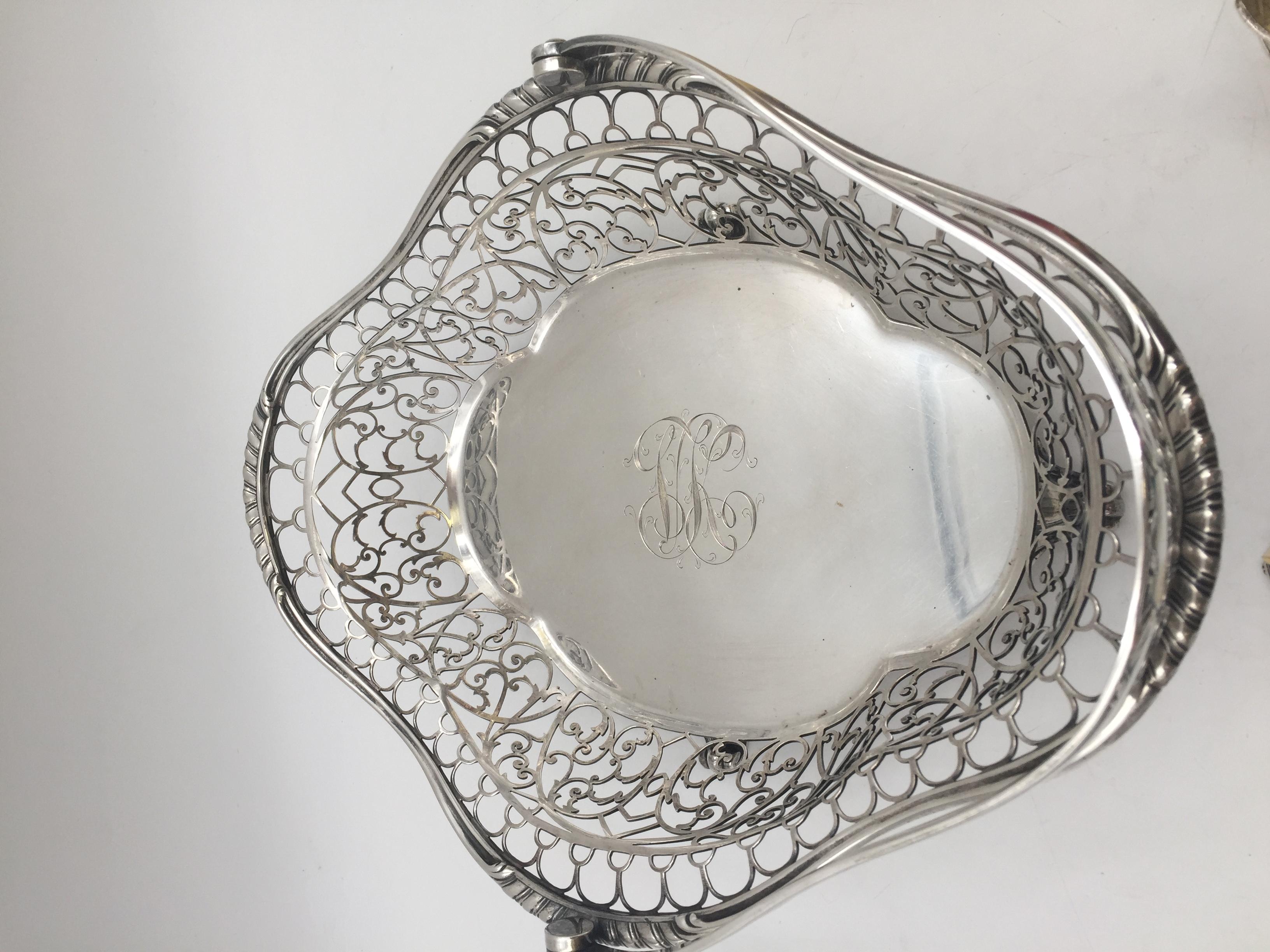 A sterling silver fruit or flower basket bowl by Marcus & Co. Pierced rim, acanthus motif on handle, standing on four scrolled feet. Measuring approximately 11 5/6 inches in length by 10'' in height by 9'' in width. Weighing 25.5 troy ounces.