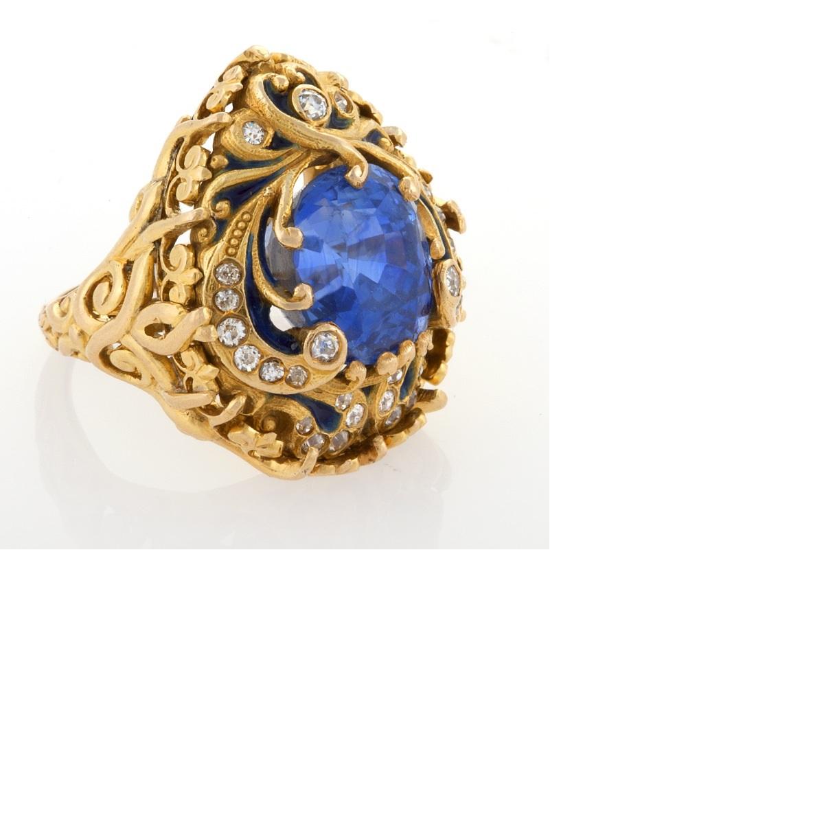 An American Art Nouveau 18 karat gold and enamel, sapphire and diamond ring by Marcus & Co. The ring has a cushion-cut blue sapphire with an approximate weight of 8.65 carats, and 27 old European-cut diamonds with an approximate total weight of .32