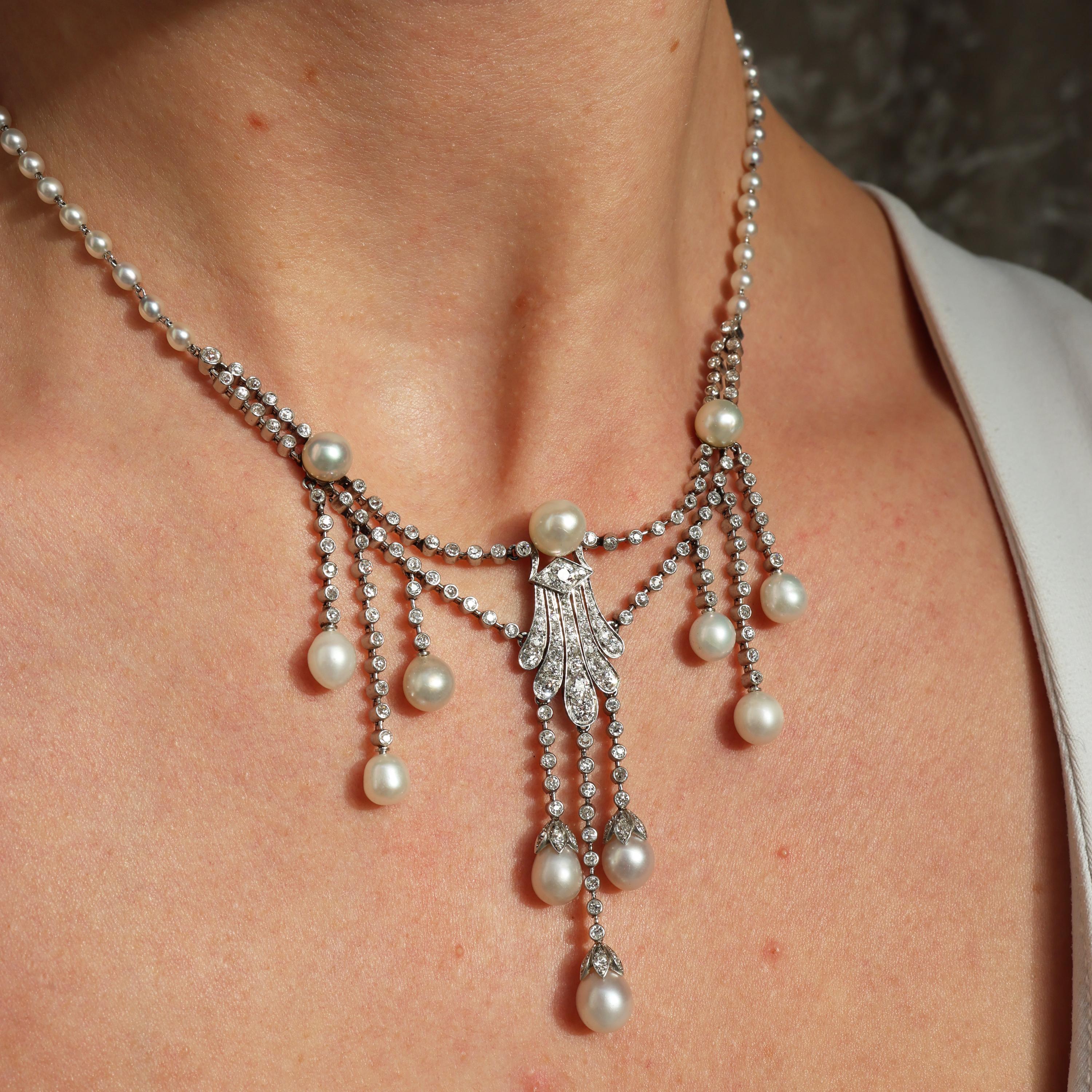 Collier pendentif en perles naturelles de Nature, diamants et platine. Le pendentif central est orné d'un motif de diamants, avec trois diamants en losange, au sommet d'une rangée de cinq diamants pavés, surmonté d'une perle, avec trois gouttes de