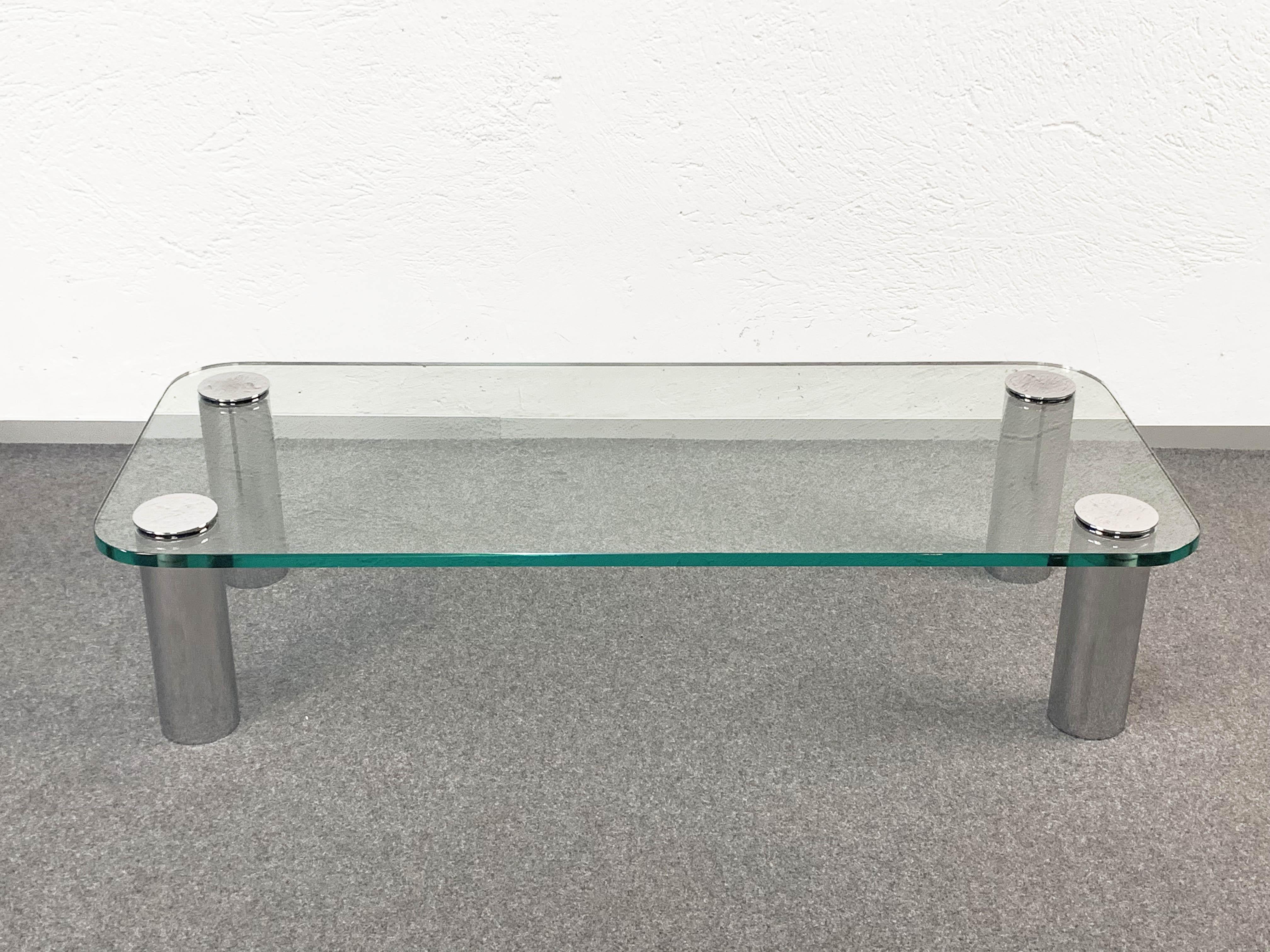 
Marcuso coffee table designed by the famous Italian architect Marco Zanuso for Zanotta, with very thick glass top, original supported by four chrome-plated screws on legs. Documented in the Repertoire by Giuliana Gramigna for the Mondadori