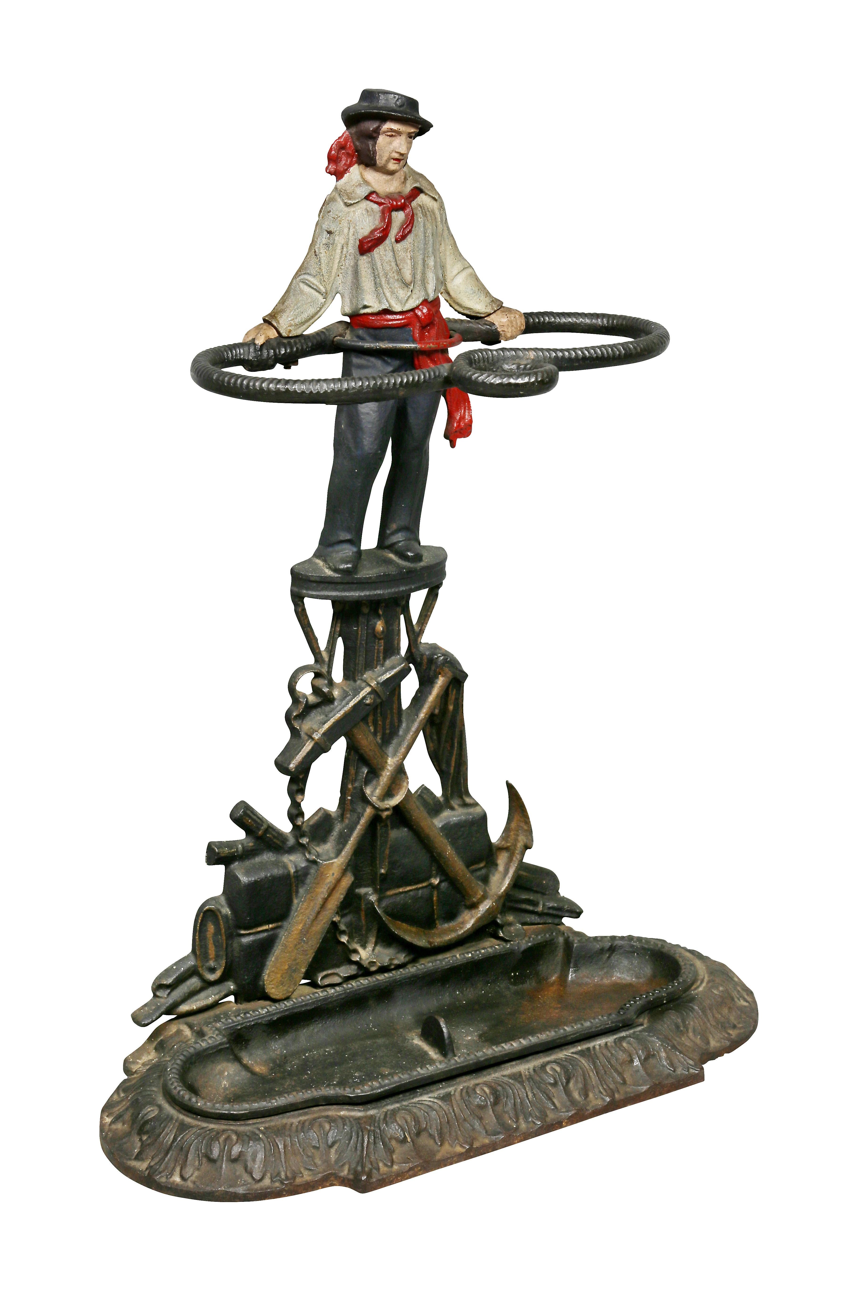 Depicting a sailor holding rope over various maritime symbols including anchor and oar, detachable drip pan. Signed and dated on back. Marcy foundry made many cast iron manhole covers etc in NYC. The business was once located at 74 Beekman street in