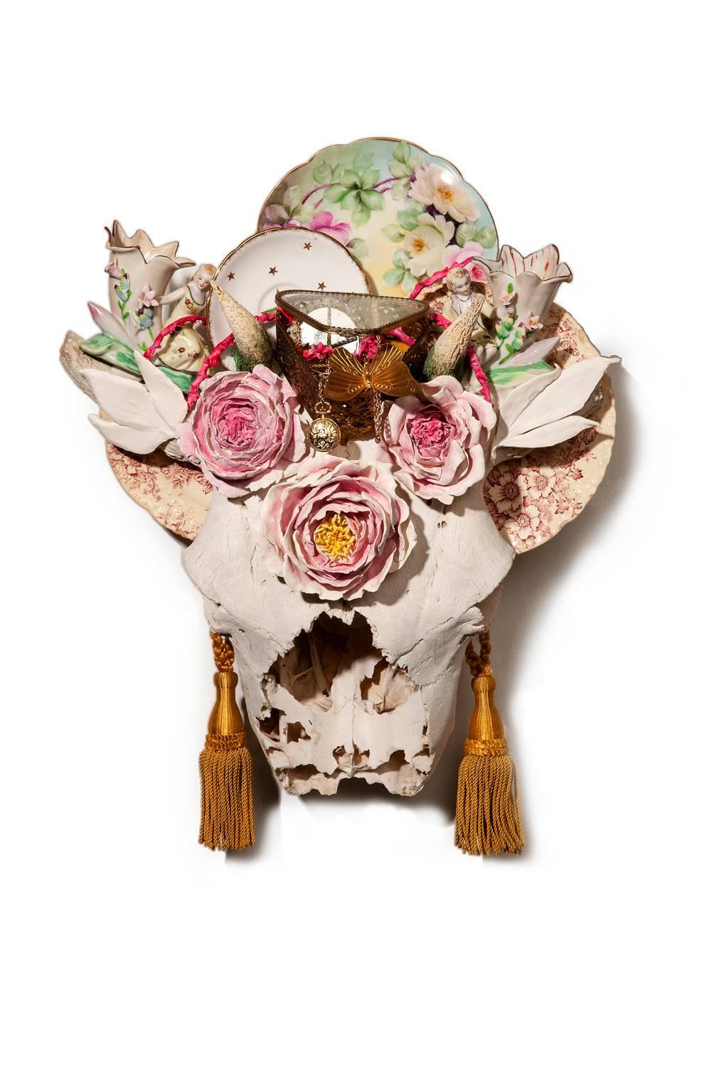 "Horns of Dilemma" sculpture, skull, found objects, handmade porcelain flowers - Sculpture by Marcy Lally