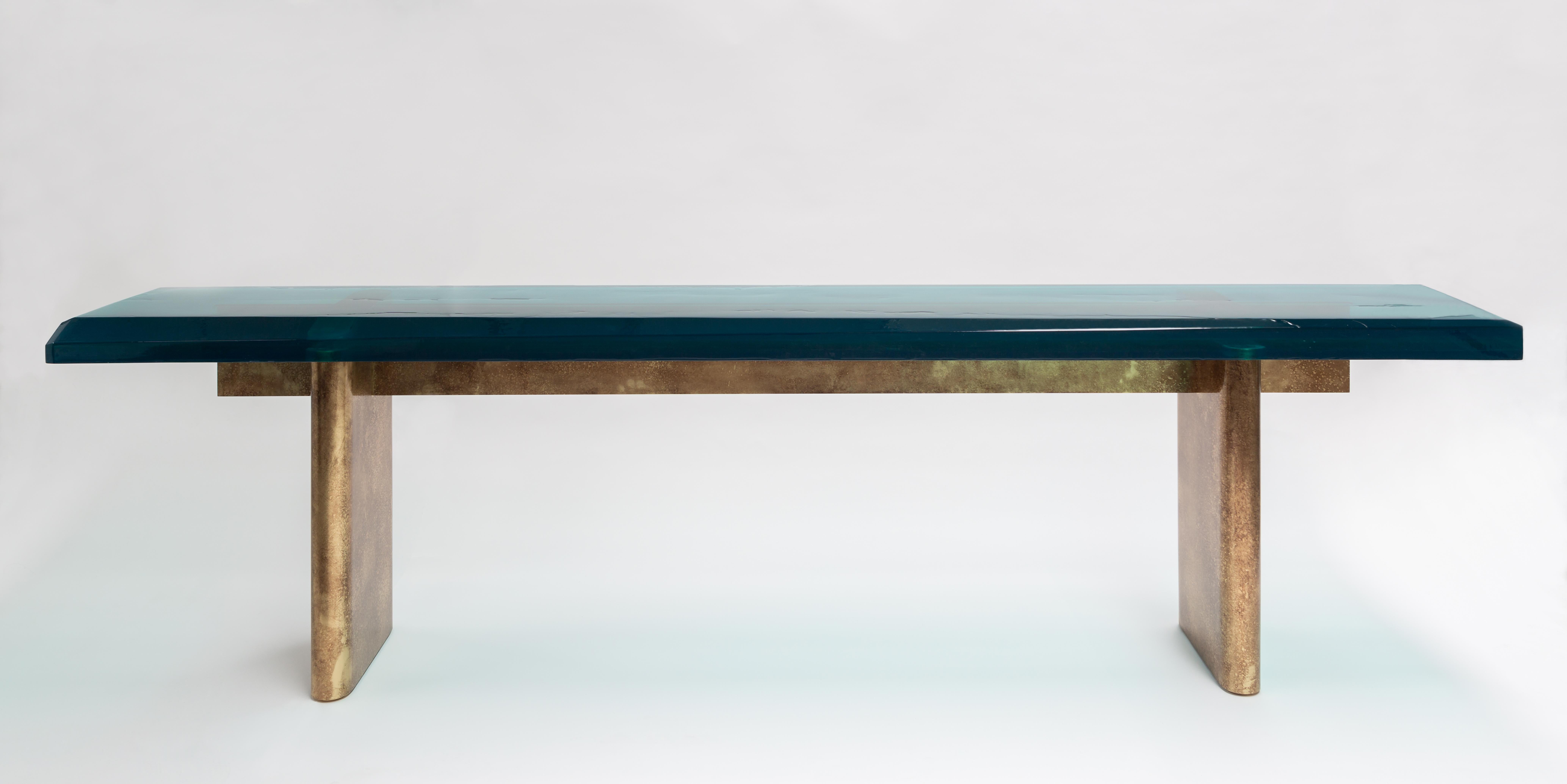 Transparency Matters collection by Draga&Aurel:
The desk features two solid brass bases and a resin cast top, designed to achieve a liquid-look surface; it is finished with brush strokes of more textured resin, applied with a fluid movement, just