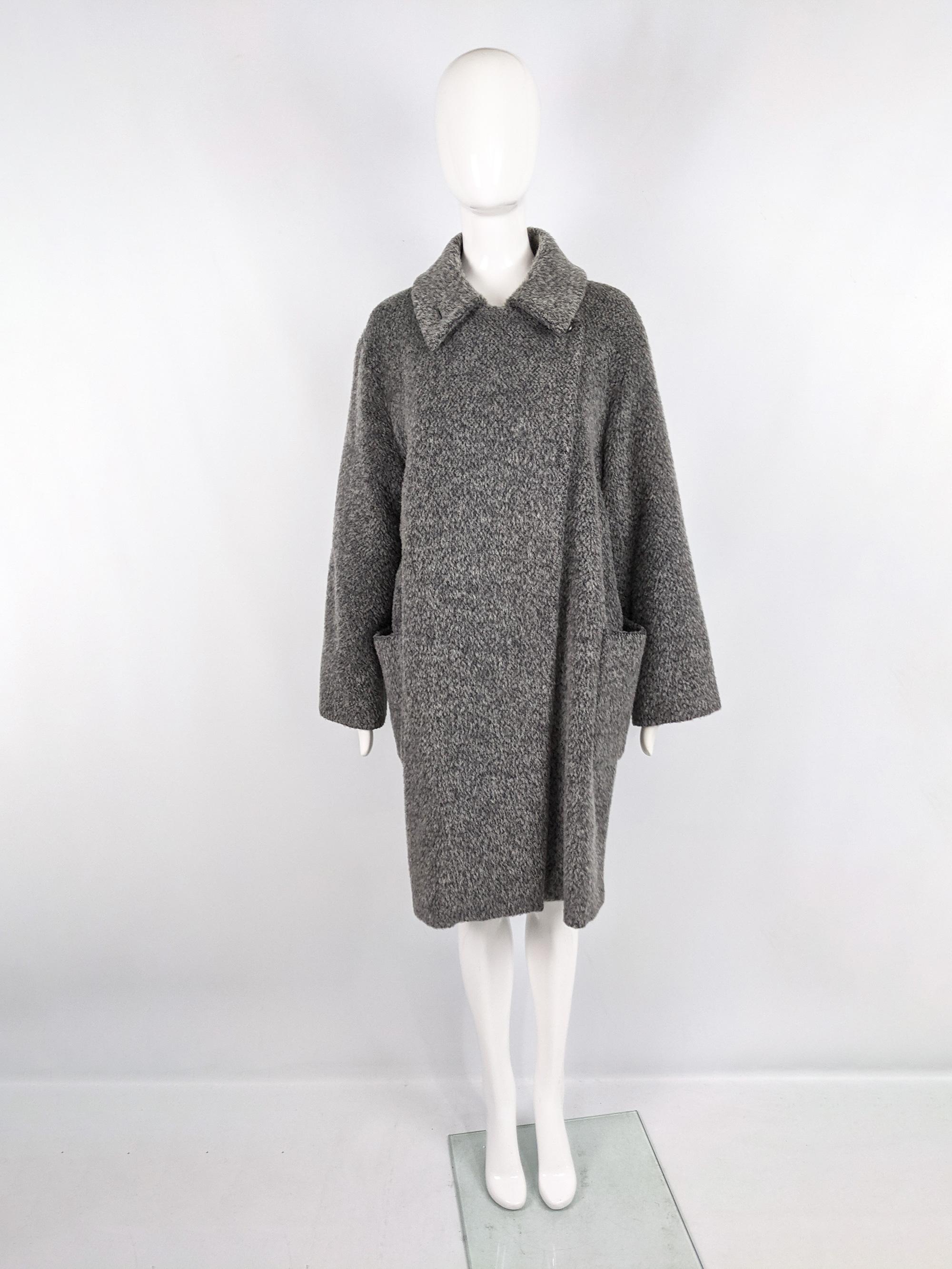 A chic, minimalist womens coat from the 90s by luxury Italian fashion group Max Mara, for their Marella line. Made in Italy, from a luxurious mohair, virgin wool and alpaca blend. It has a minimal feel with a loose, oversized trapeze style cut and