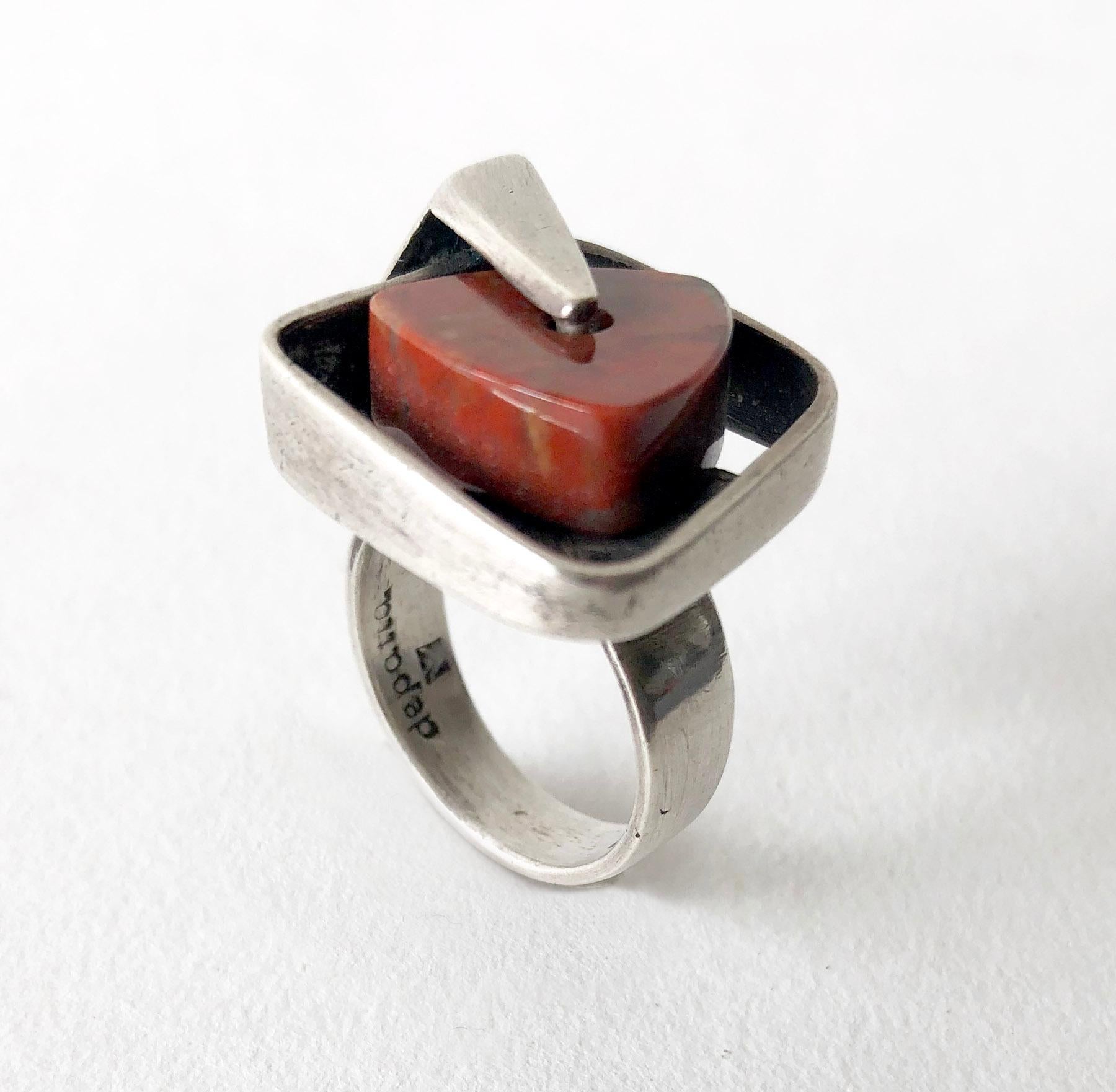 Sterling silver ring with triangular agate stone that spins within its setting, created by Margaret De Patta of San Francisco, California.  Ring is a finger size 6.5 to 7.  Signed De Patta and the artists' hallmark.  In very good vintage