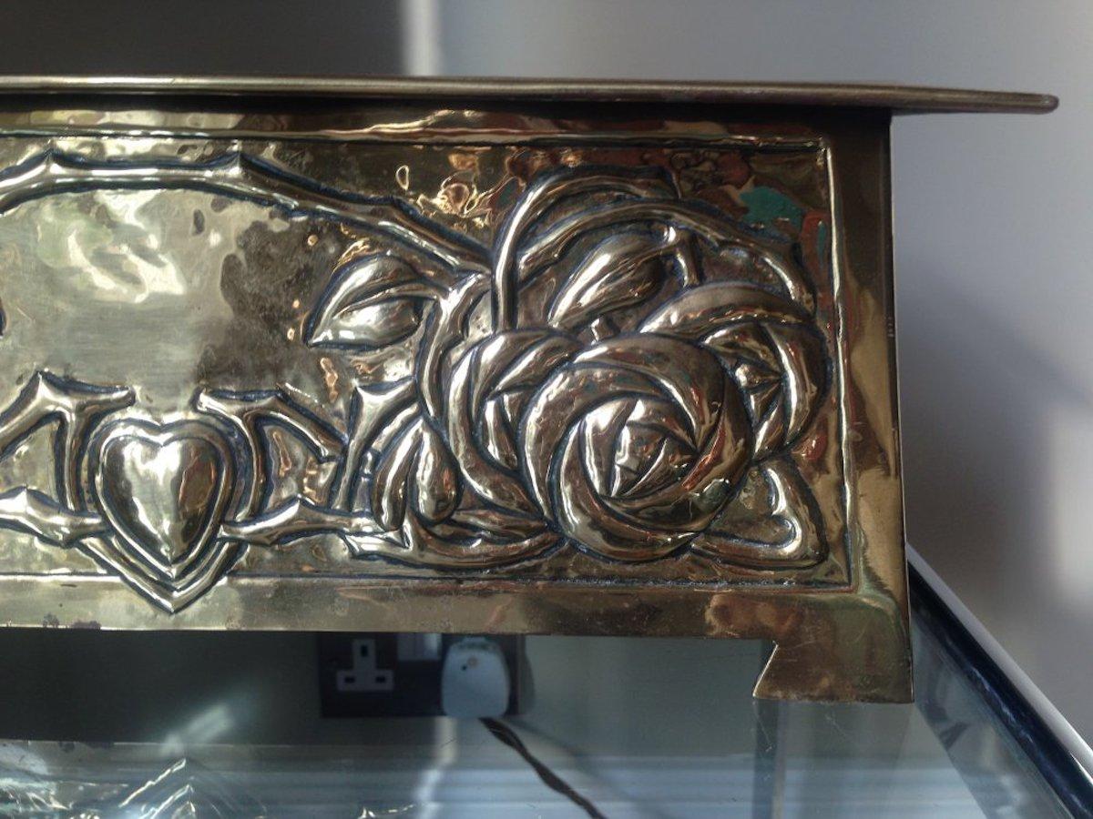 Margaret Gilmour, attributed. A Glasgow School brass planter with stylized rose and floral details.
