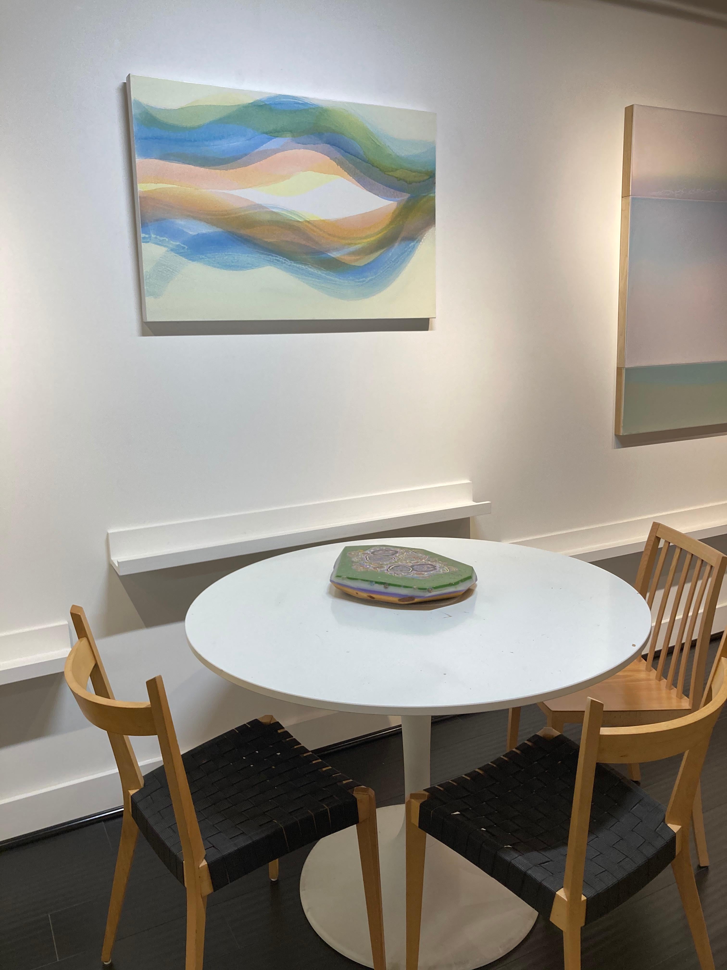 Shades of light blue, pale orange and light green are layered over a soft, luminous pale yellow and white background by Margaret Neill investigates the properties of abstract curvilinear forms found in the localized conditions of her surrounding