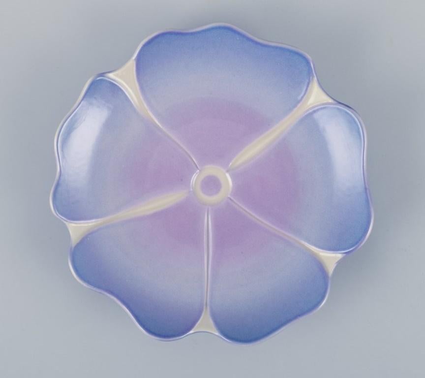 Margareta Hennix for Gustavsberg Studiohand, Sweden.
Unique ceramic bowl shaped like a flower. 
Glazed in shades of purple.
Approximately from the 1980s.
Signed.
In perfect condition.
Dimensions: D 17.2 cm x H 2.5 cm.
