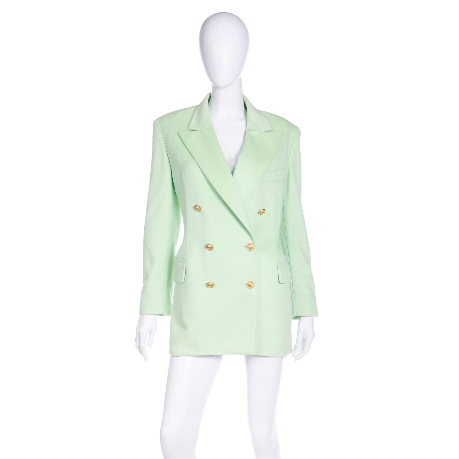 We love vintage Escada and this minty lime green cashmere blend jacket will carry you through the Summer months and year round. This double breasted blazer style jacket has the signature branded Escada rayon lining, notched lapels, built in shoulder