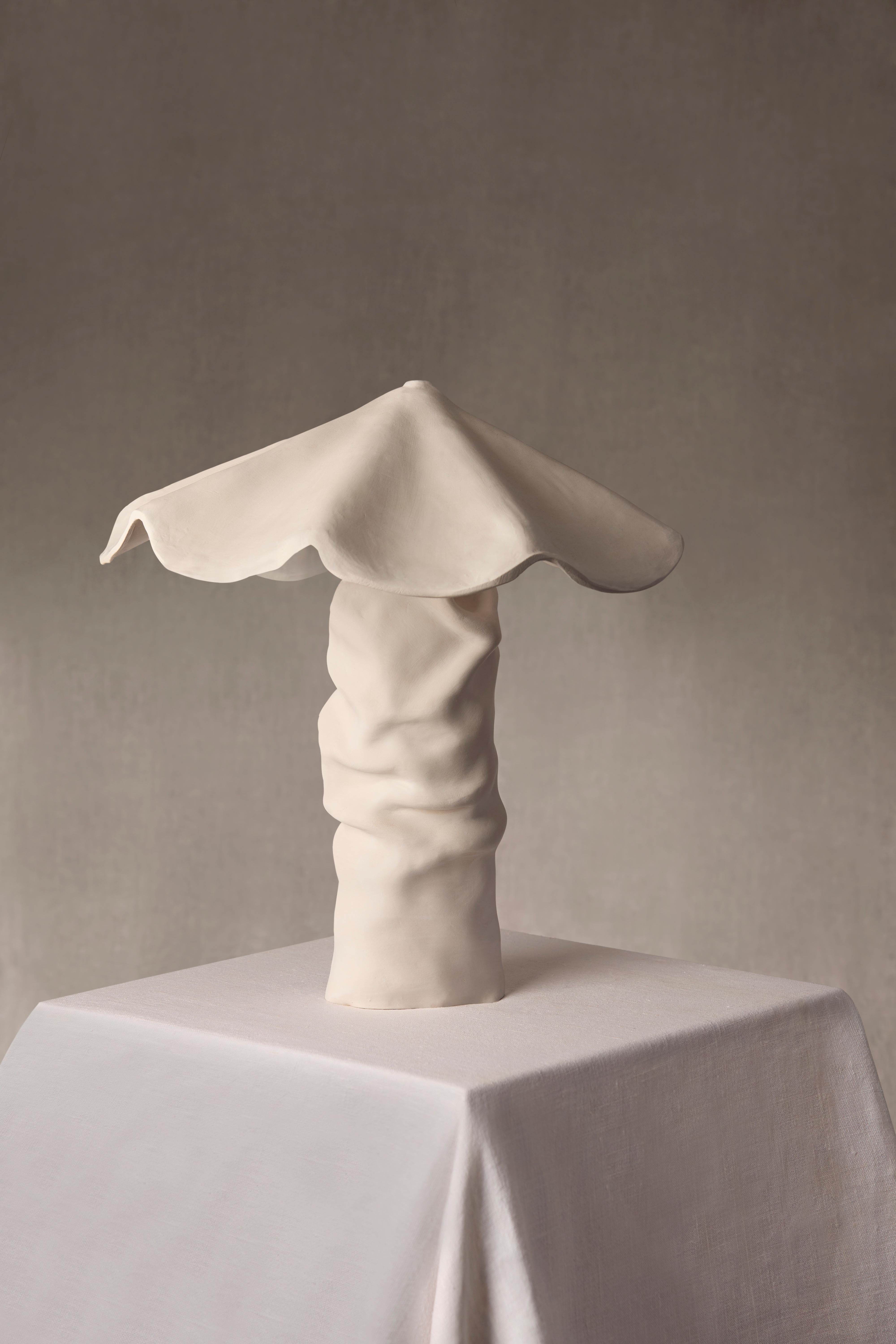 Margarita is part of Carrillo Studio’s Cadaqués Collection—a sculptural table lamp that celebrates simplicity as a form of quiet beauty. Hand-built in high-fired white stoneware and finished with a matte white slip, its surface carries a calm and
