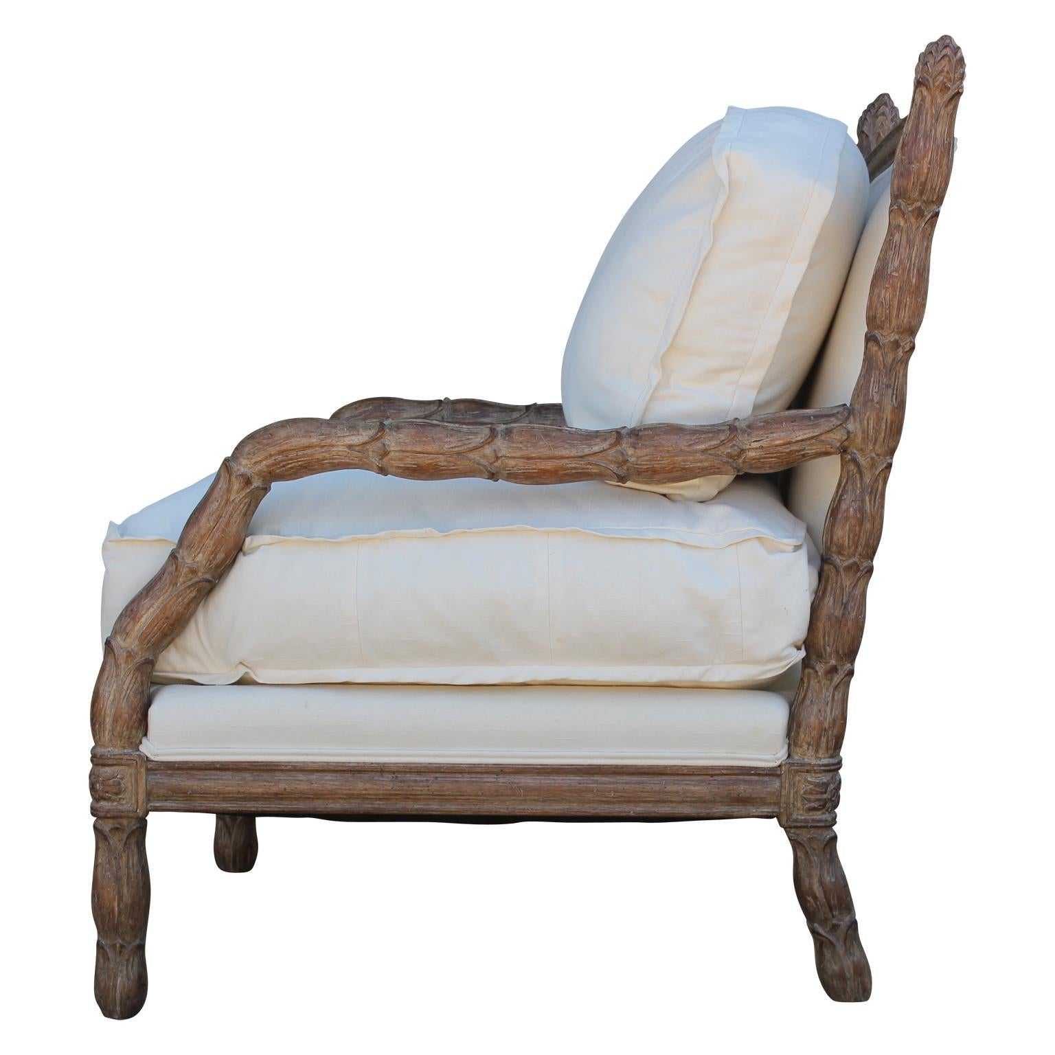 A beautiful Marge Carson carved French style bergere chair. The white fabric is in wonderful vintage condition but could be reupholstered in fabric of your choice, circa 20th century.