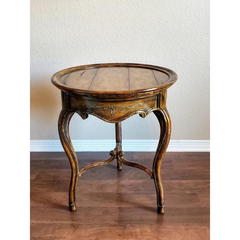 Sophisticated, elegant, timeless, unfussy comfort, functional and versatile, the exquisitely handcrafted Les Marches round table by Marge Carson blends the different elements to create a true masterpiece. This beautiful antique reproduction enhanced