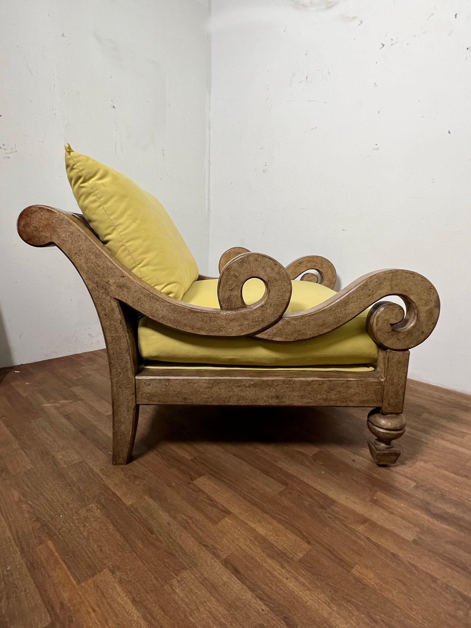 An extremely oversized post modern lounge chair in burled finish with serpentine arms, including a matching ottoman, by Marge Carson, ca. 1980s.

Chair measures 43.25