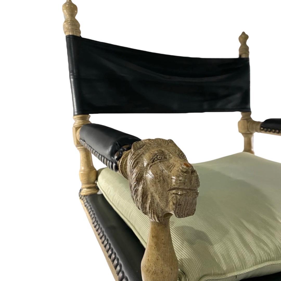 Marge Carson

Pair of Unique Campaign Chairs

Beautiful Carved Wood with a Lion Motif

Driftwood Oak and Black Leather Sling Seat/Back with Brass Support Bar Under
Seat/Back

Leather Arm Padding, Seats and Backing Fastened with Stud