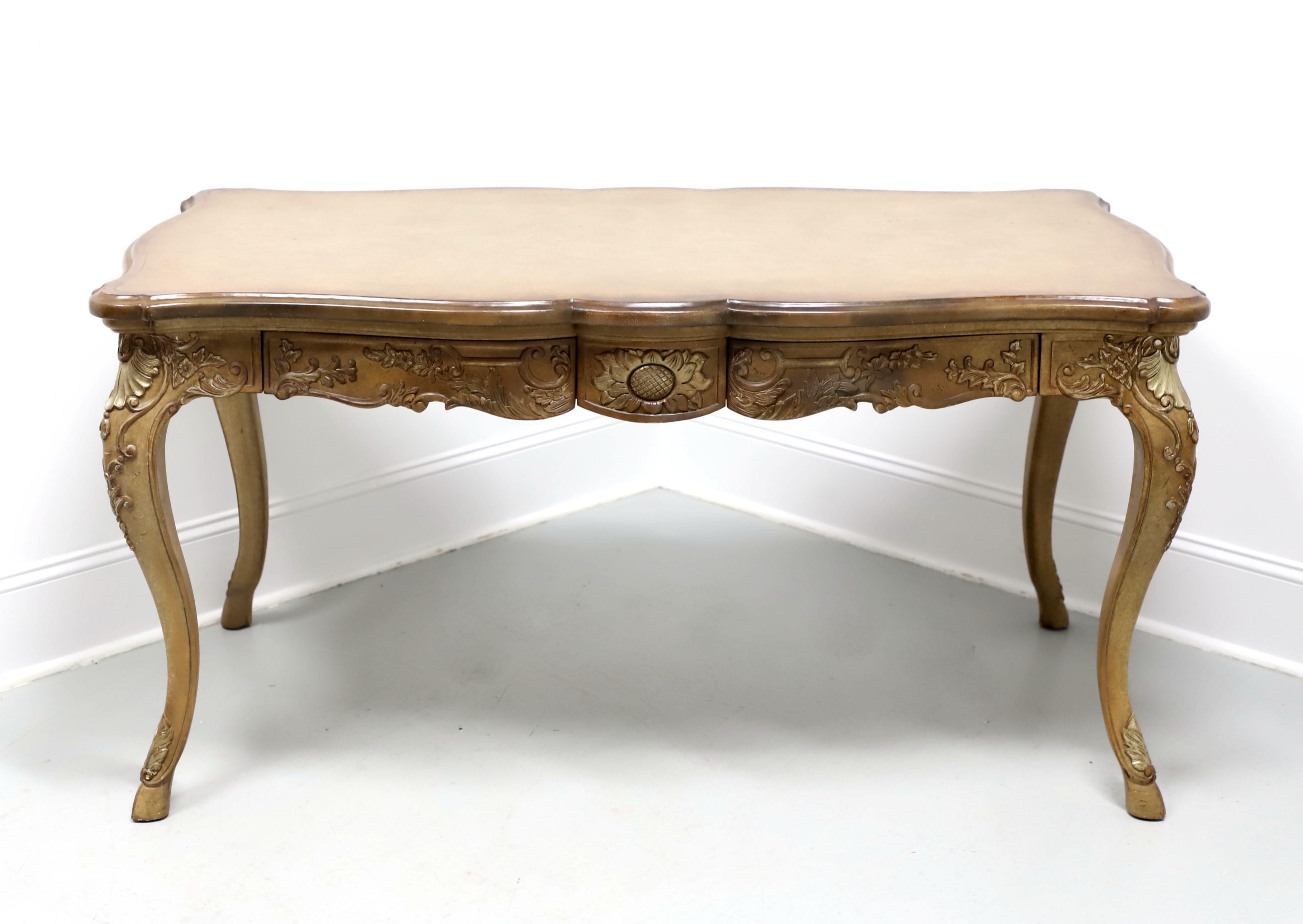 A French Provincial style bureau plat writing desk by Marge Carson, of Pamona, California, USA. Whitewashed oak, slightly distressed, banded top with a bevel edge, subtle rounded edges, decorative carving to apron, knees & legs, curved legs, and