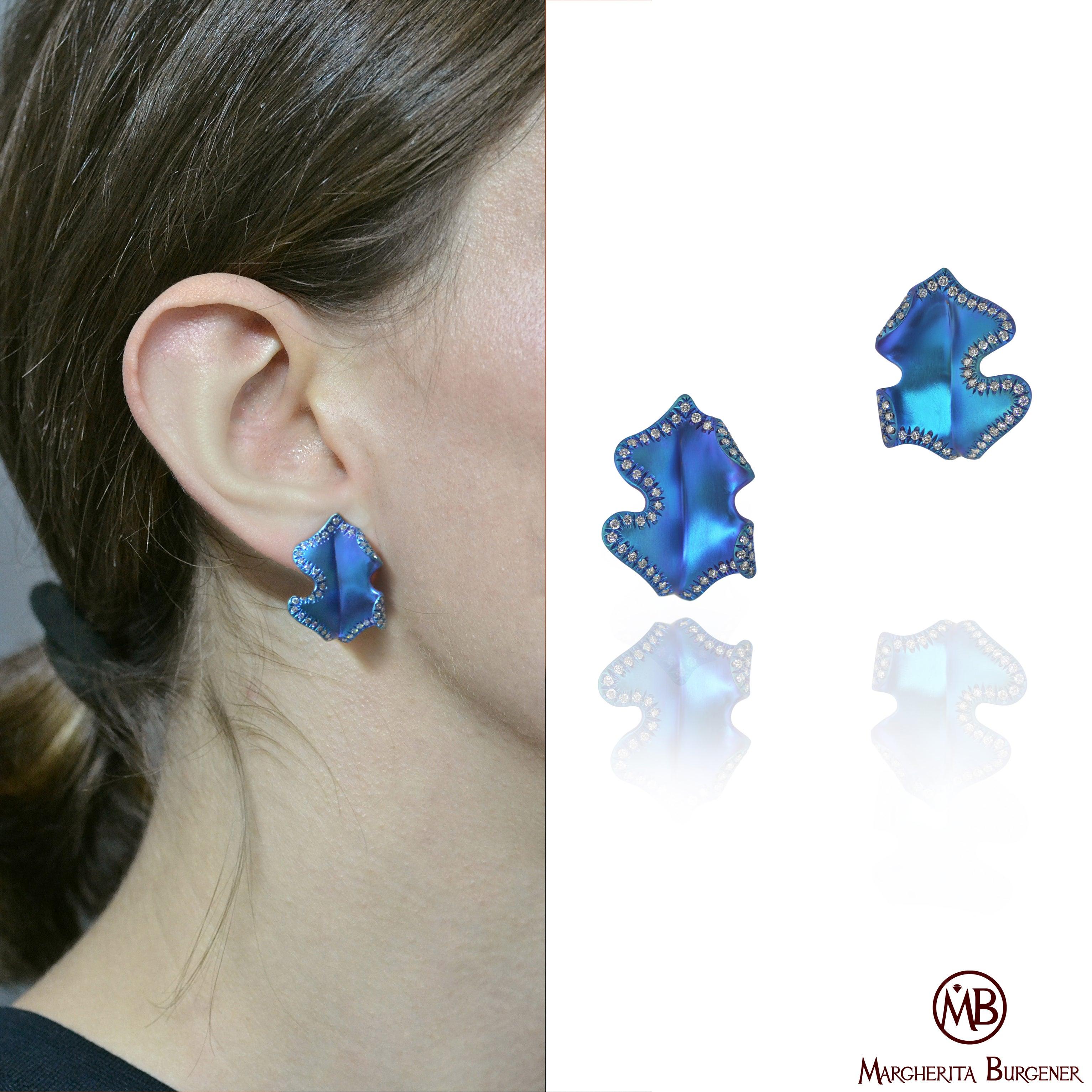 These very original 'Ghiande' earrings are handmade, on order, in Margherita Burgener family workshop, Italy.
Handmade in titanium, they feature diamonds and anodized teal color.
On request you can have them in yellow, pink, green.

Titanium
18 KT