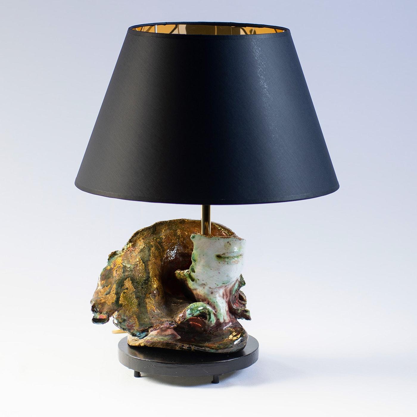 Topped by a timelessly elegant conical shade that is black con the outside and glossy gold on the inside, this table lamp is a unique work of art by artist Angelo Salemi. A circular, footed wooden base finished in polished black sustains the