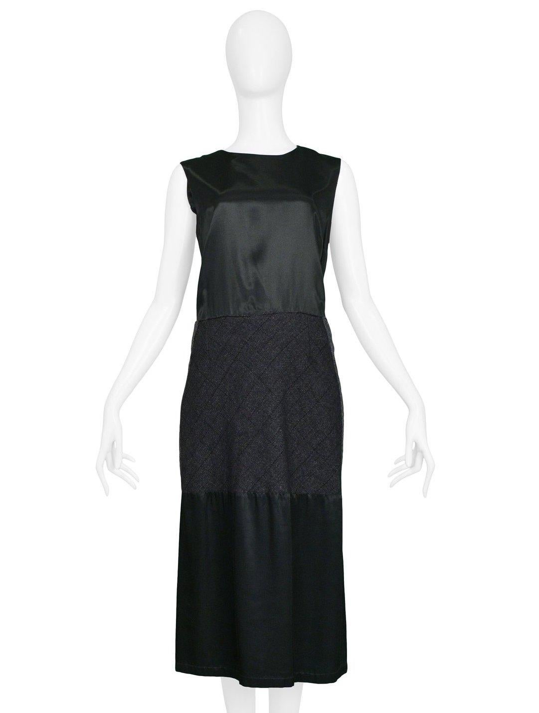Resurrection Vintage is excited to offer a vintage Maison Martin Margiela artisanal reconstructed sleeveless dress featuring two black satin fabric panels at the torso and hem, a center wool panel covering the waist and hips. The dress features a