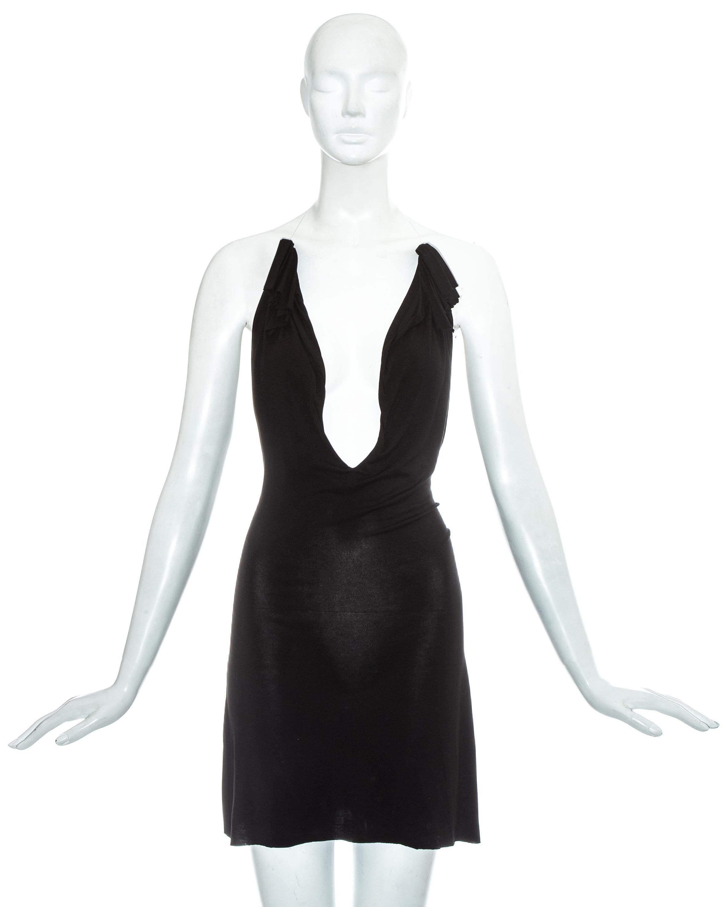 Martin Margiela black rayon mini dress with invisible wire halter neck straps to create an illusion of a floating dress. Low back and adjustable knot fastening on lower back. 

Spring-Summer 2005