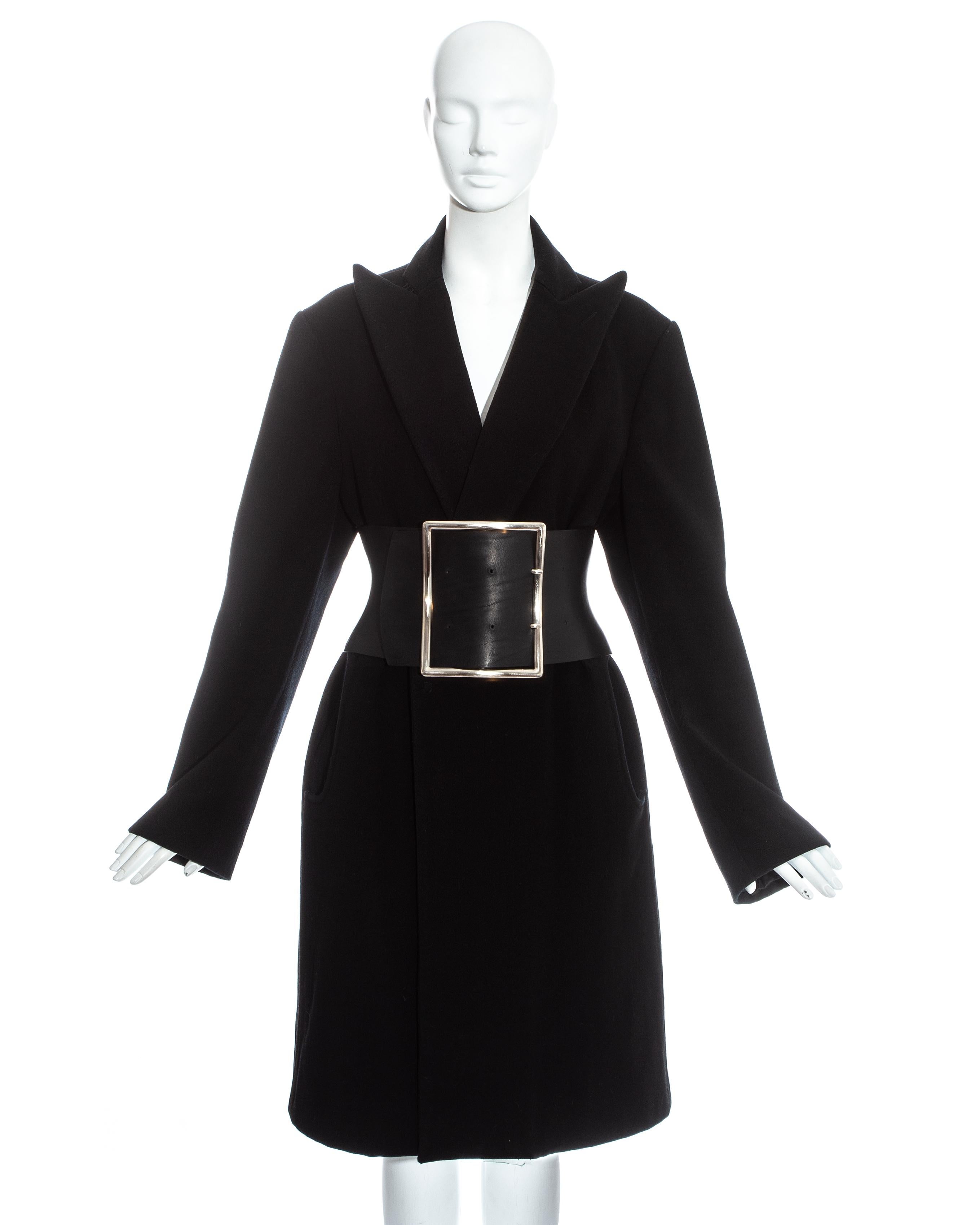 Martin Margiela; black wool oversized coat with exaggerated pointed lapels and snap button closure, paired with the signature extra wide leather Obi corset belt with metal buckle and adjustable fastening at the back.

Fall-Winter 1996

Notes on the