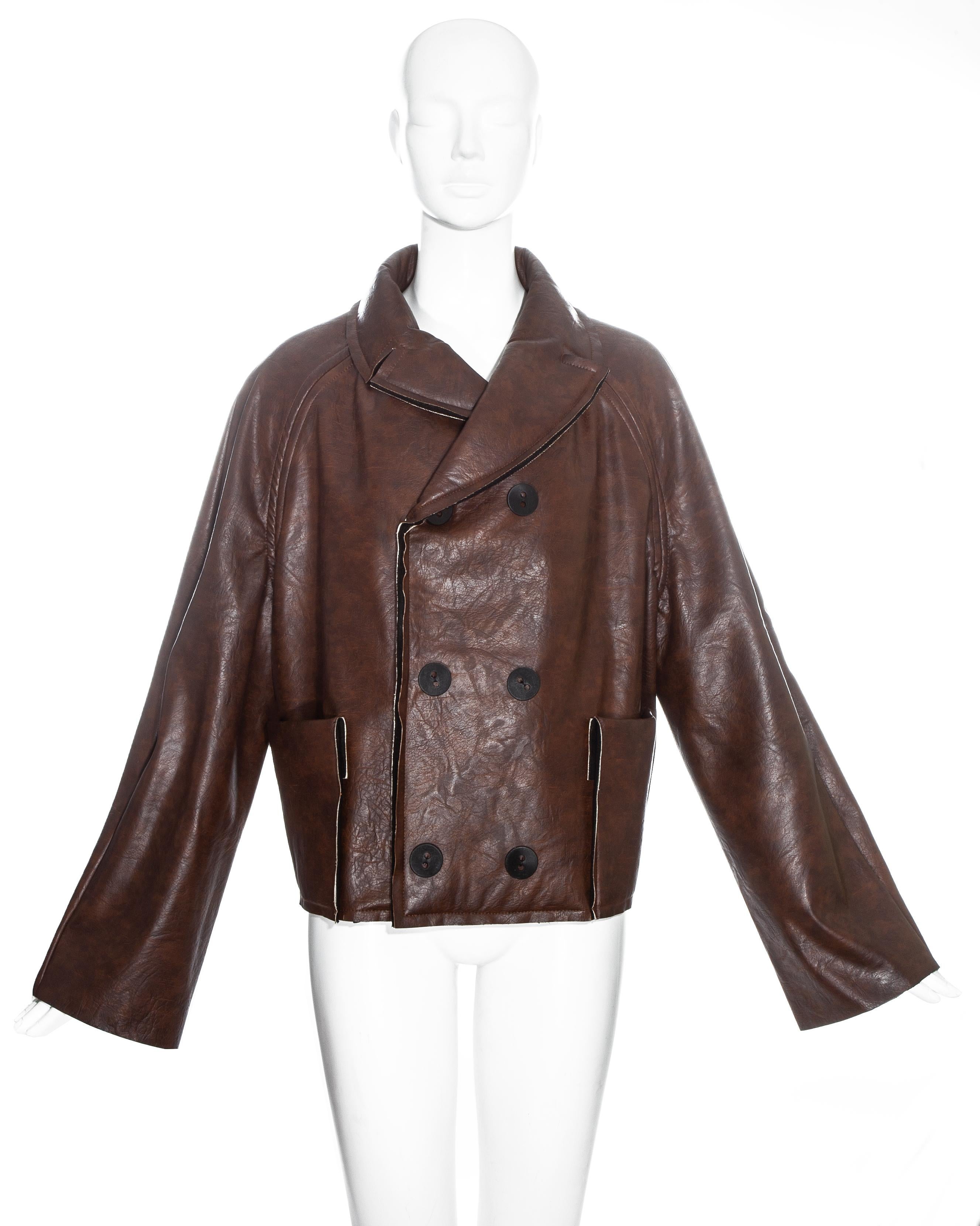 Martin Margiela brown leatherette double breasted jacket with large snap button closures, exposed seams and two front patch pockets. For this collection Margiela reproduced doll's clothing and enlarged them to human size.

Fall-Winter 1994