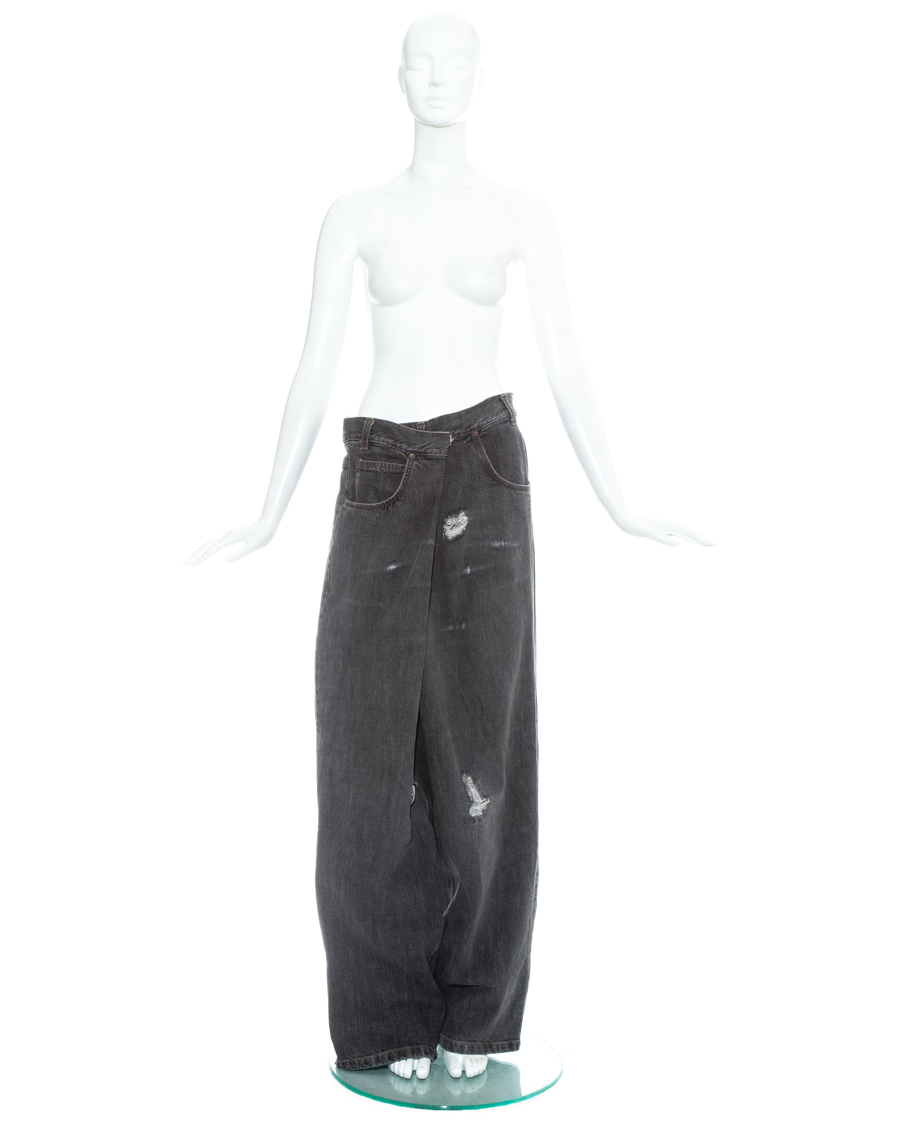 Martin Margiela; grey denim oversized jeans. Size IT 78 reconstructed to fit a size Medium. Artificial distressed design, box pleat at the centre back, wrap design at front fastening with a hook and eye closure.   

Fall-Winter 2000
