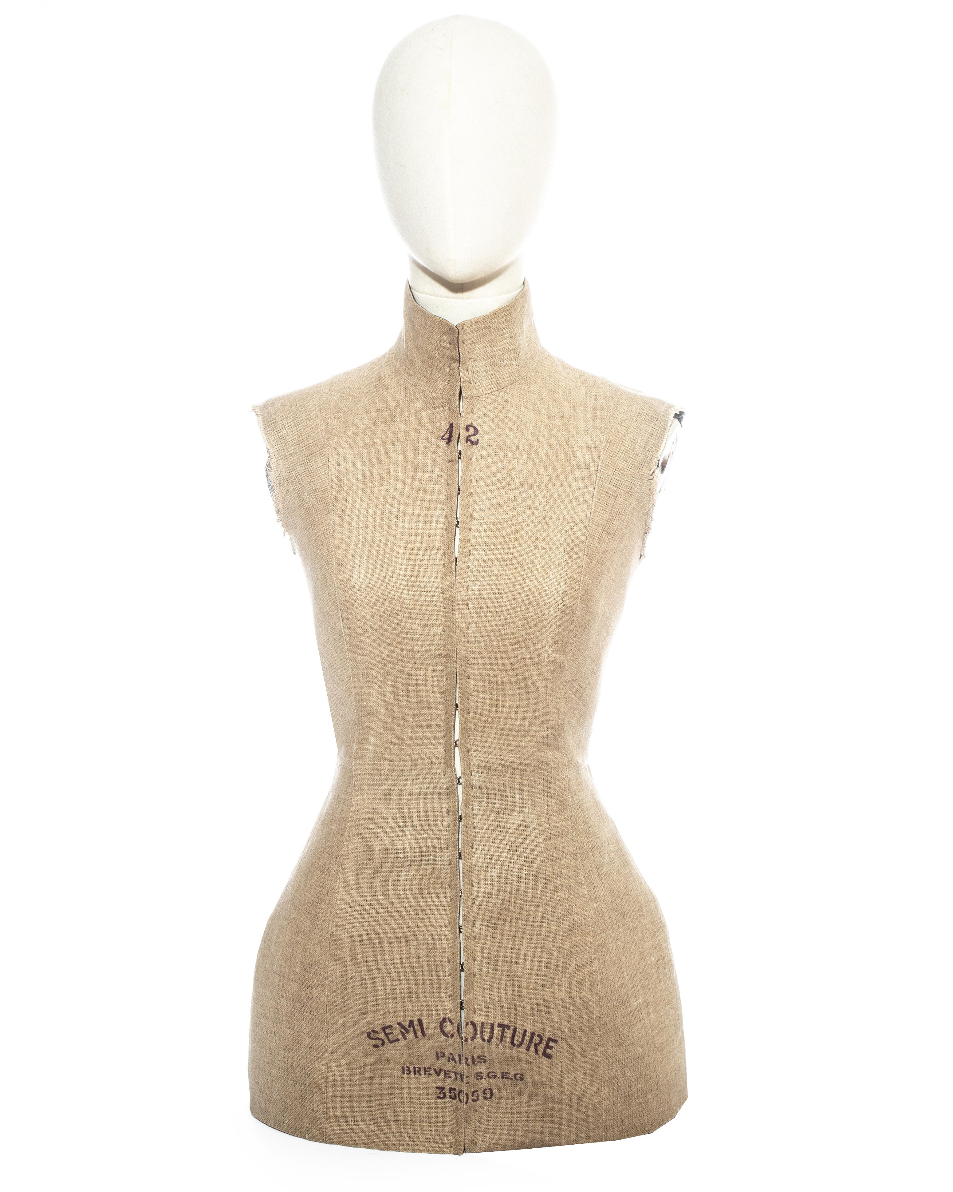 Martin Margiela; Linen Semi Couture Stockman corseted waistcoat. Stamped in black ink resembling a traditional Stockman mannequin bust. Metal hook and eye fastenings at the centre front, high neck, black cotton lining, and raw edges around the