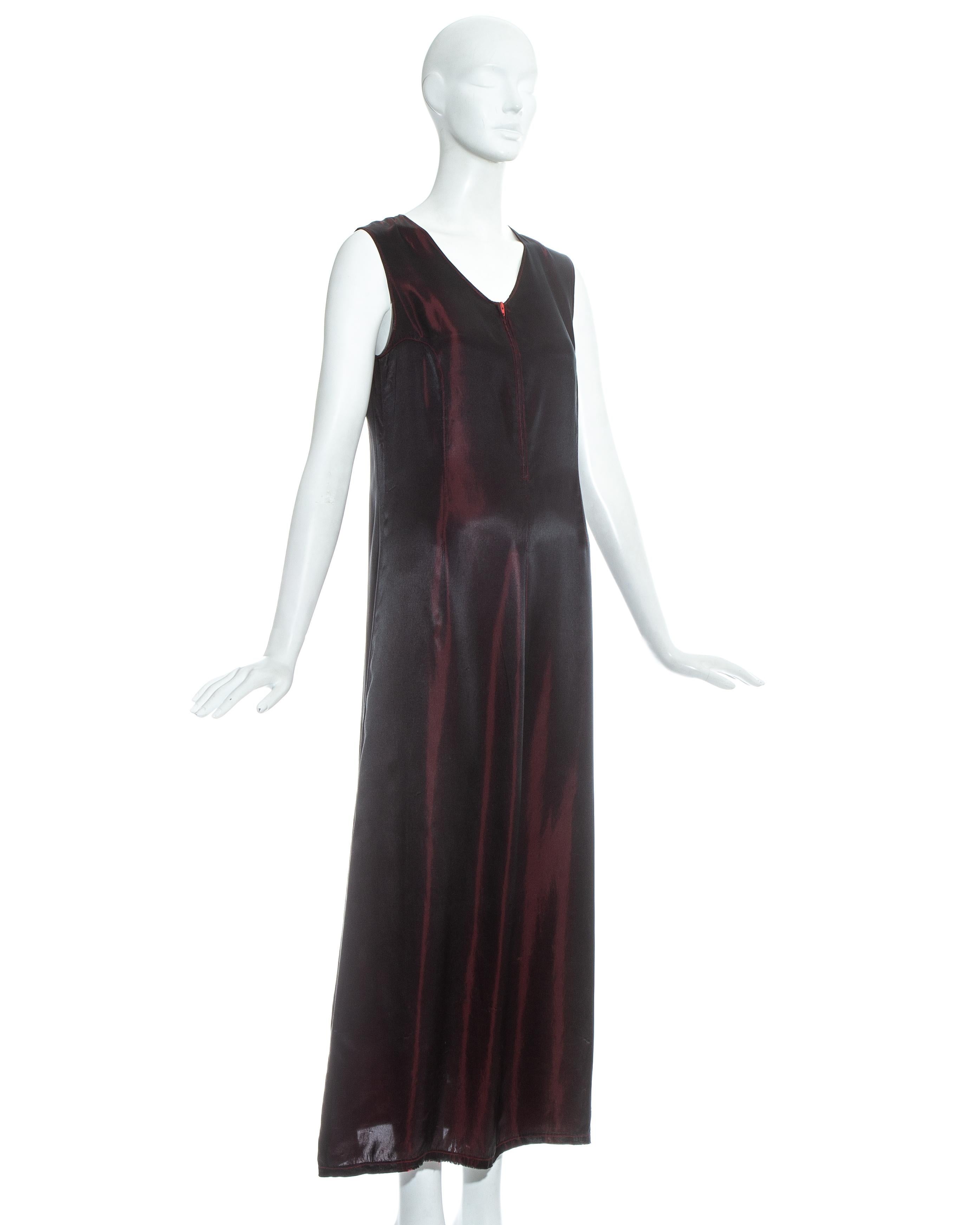 Martin Margiela; red and black iridescent rayon maxi slip dress. Zip fastening at centre front, darts at back neck, princess seams through bust points and intentional loose seam at mid centre back exposing wrong side of fabric.

Fall-Winter 1997