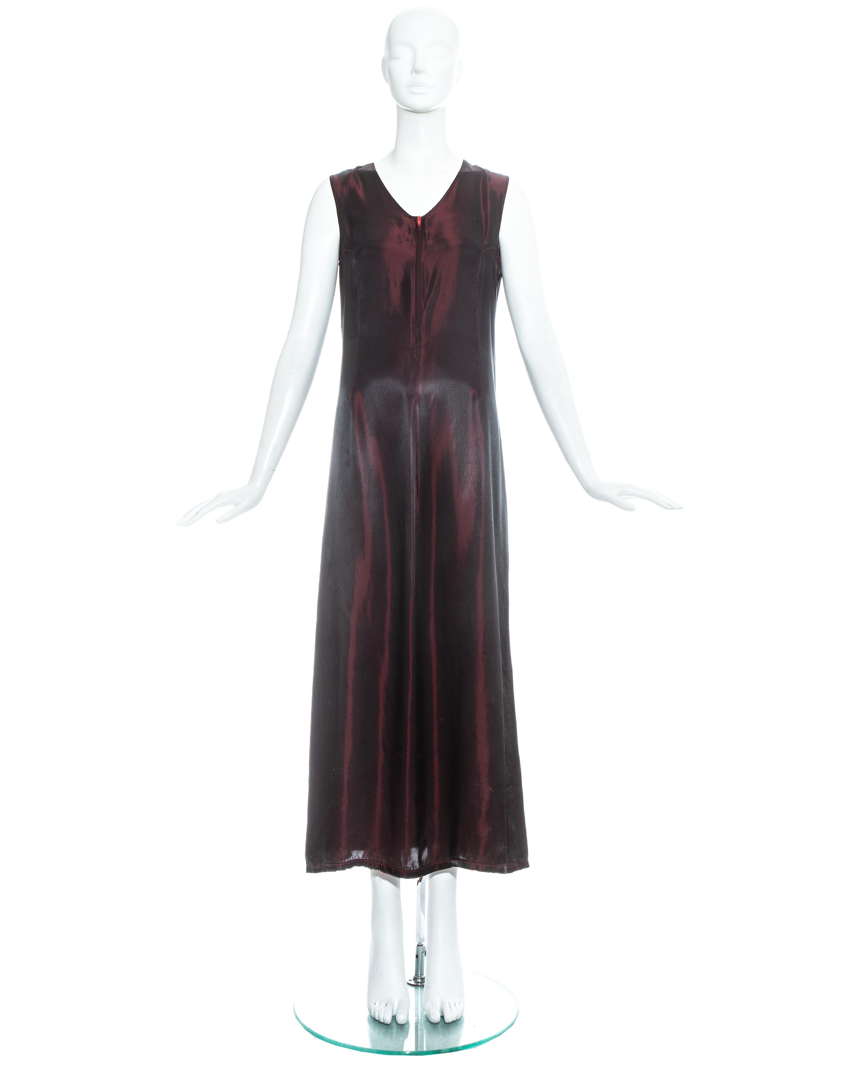 Martin Margiela; red and black iridescent rayon maxi slip dress. Zip fastening at centre front, darts at back neck, princess seams through bust points and intentional loose seam at mid centre back exposing wrong side of fabric. 

Fall-Winter 1997