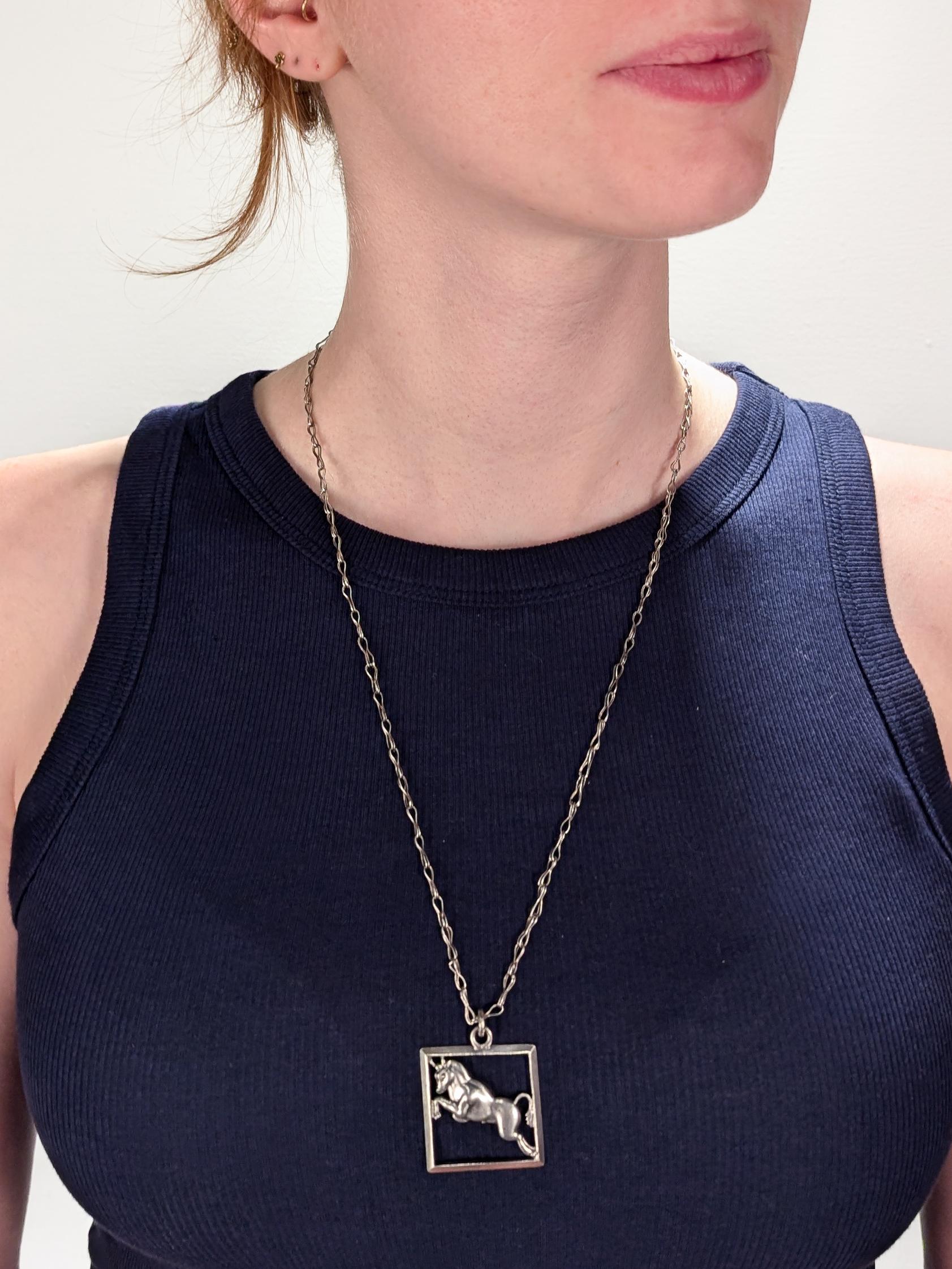 A fine Mexican Mid-Century astrological necklace.

By Margot de Taxco.

In sterling silver.

Comprising a diamond shaped pendant centered on a leaping bull Taurus astrological sign with integral bail suspended by a long Infinity-variant wire link