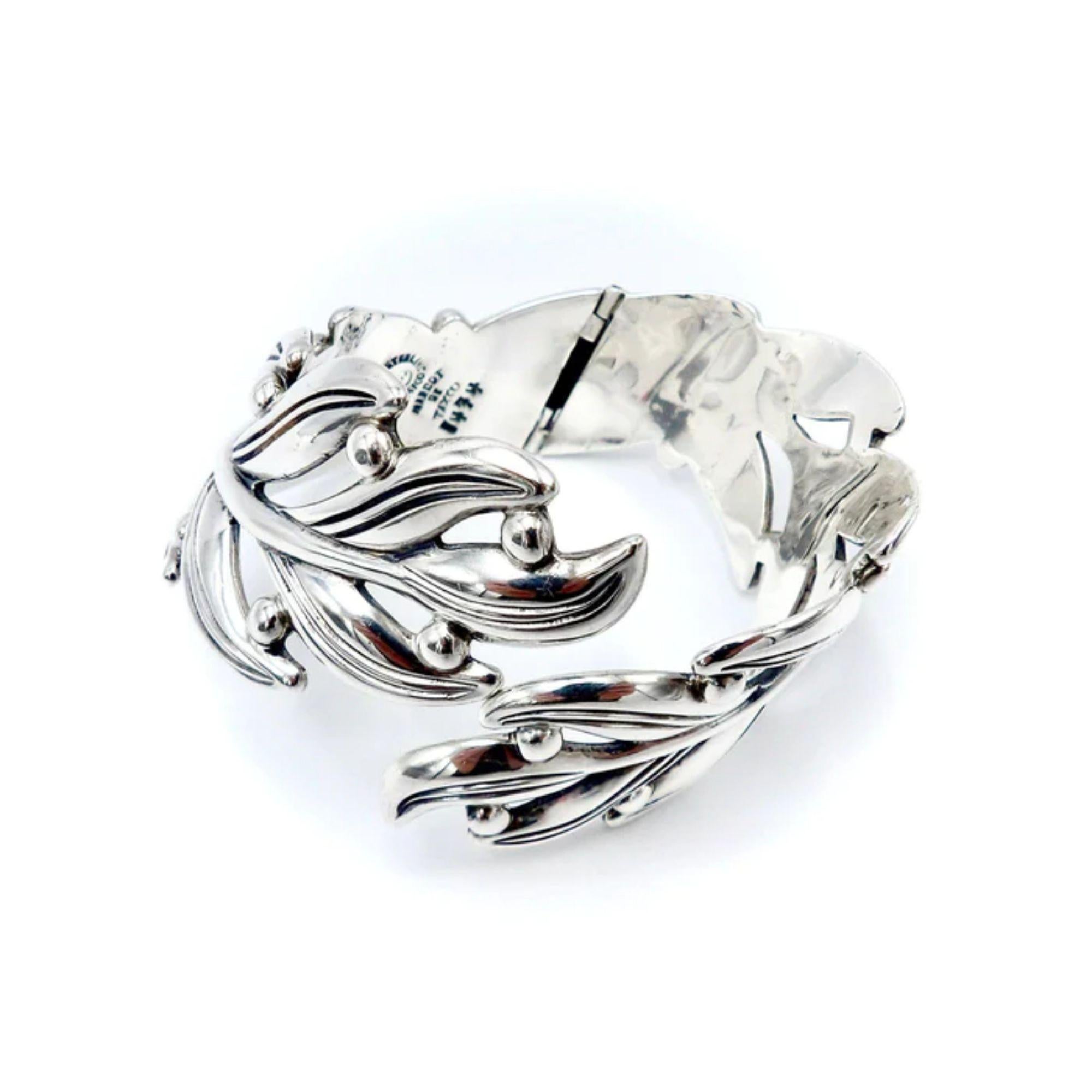 Margot De Taxco Sterling Silver Leaf Bracelet
 
A beautiful sterling silver hinged clamper bracelet by Margot De Taxco, made in Mexico, in a modernistic, stylized leaf design with flat and curved surfaces. This Margot de Taxco design is known as
